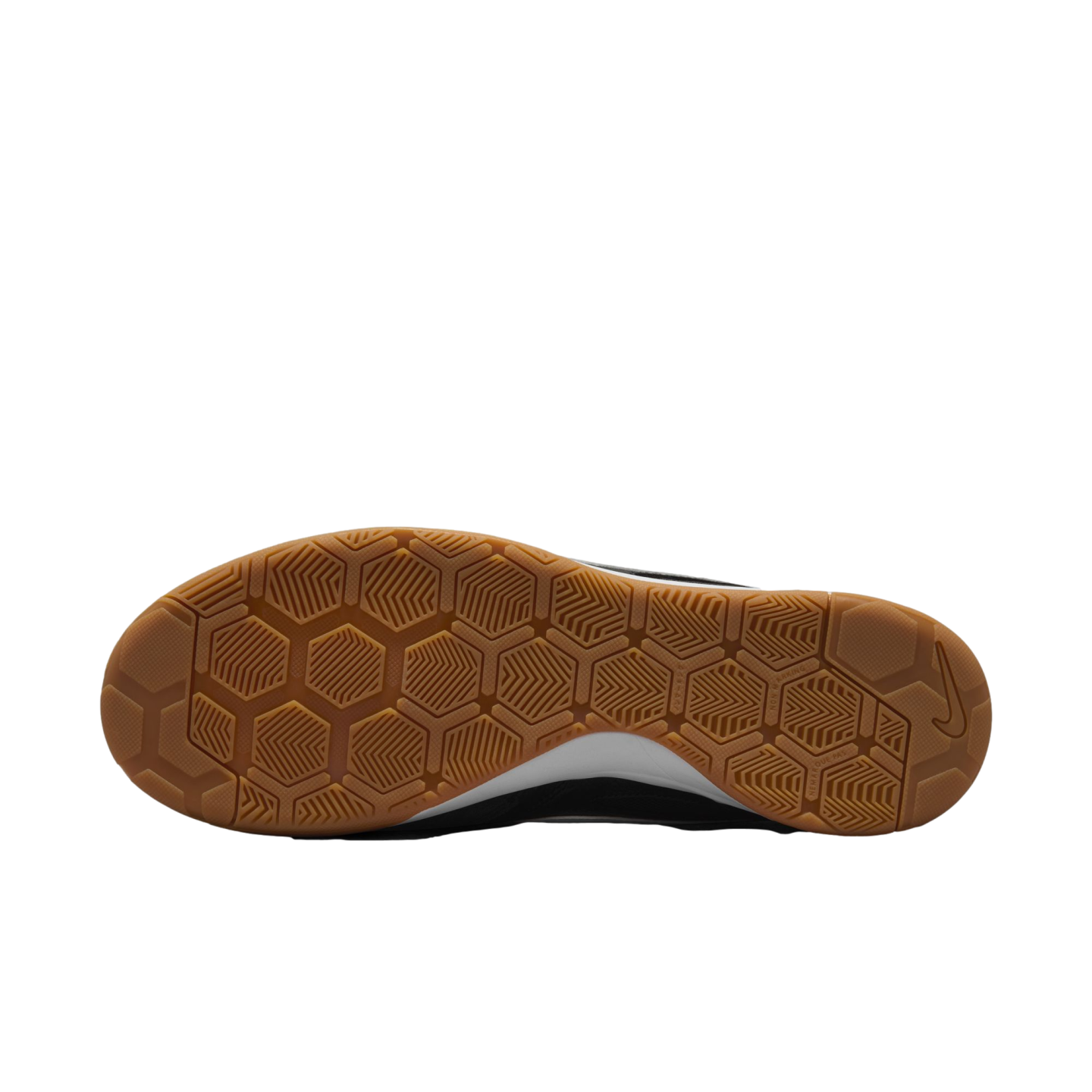 The bottom of a black and white Nike shoe, featuring a gum rubber outsole with a multi-directional honeycomb and herringbone traction pattern.
