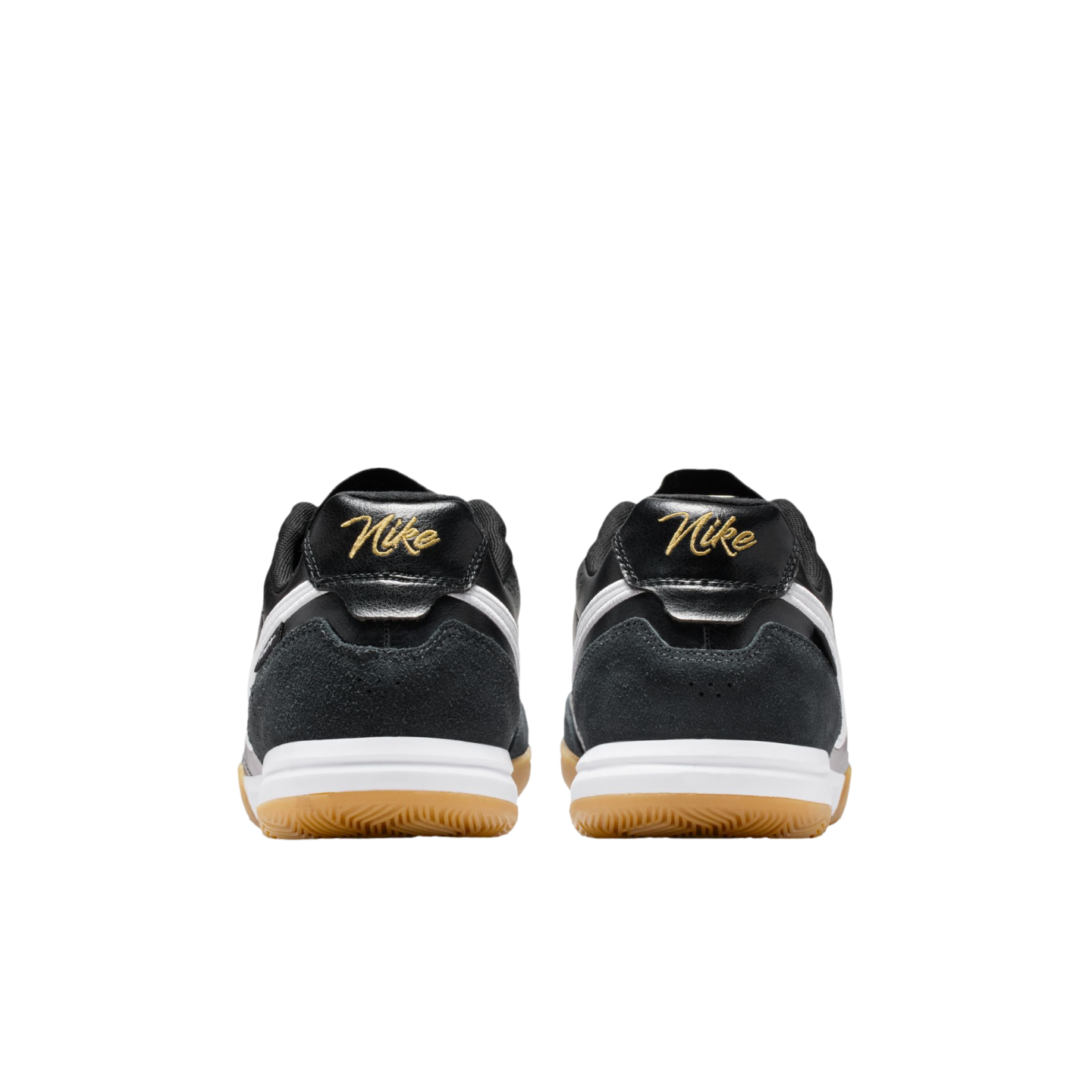 Rear view of two black Nike sneakers with gold script logos on the heels, white midsoles, and tan gum outsoles against a solid black background.