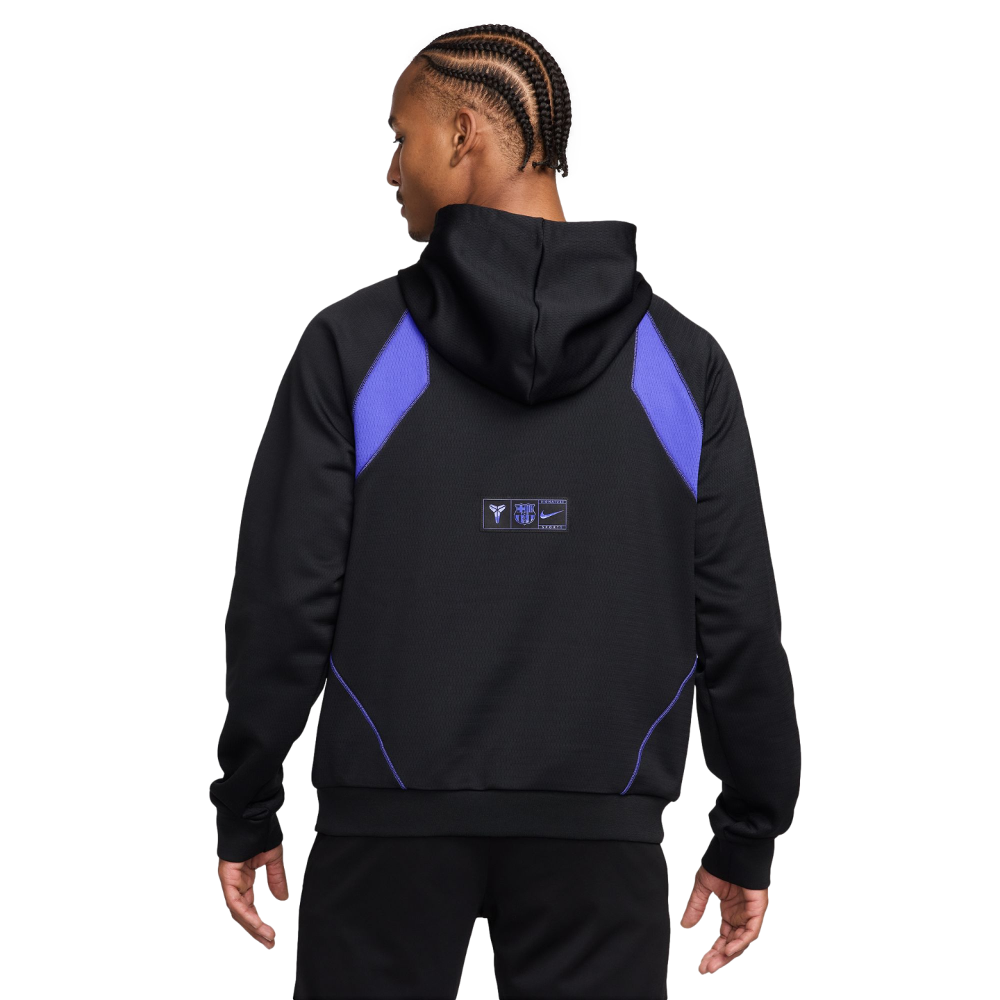 Back view of a person with braids wearing a black Nike hoodie with purple shoulder panels and small logos on the back.