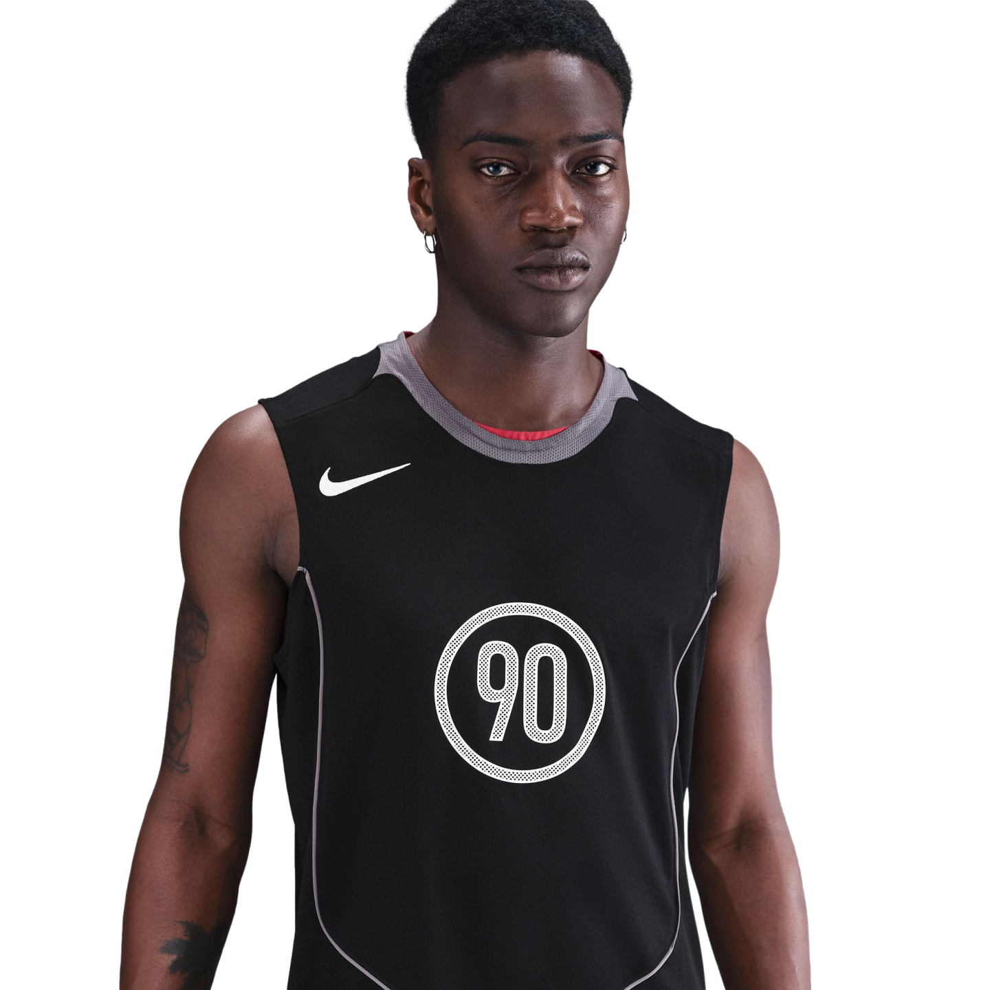 A young Black man wearing a black Nike sleeveless jersey with the number 90 in a white circle, against a solid black background.