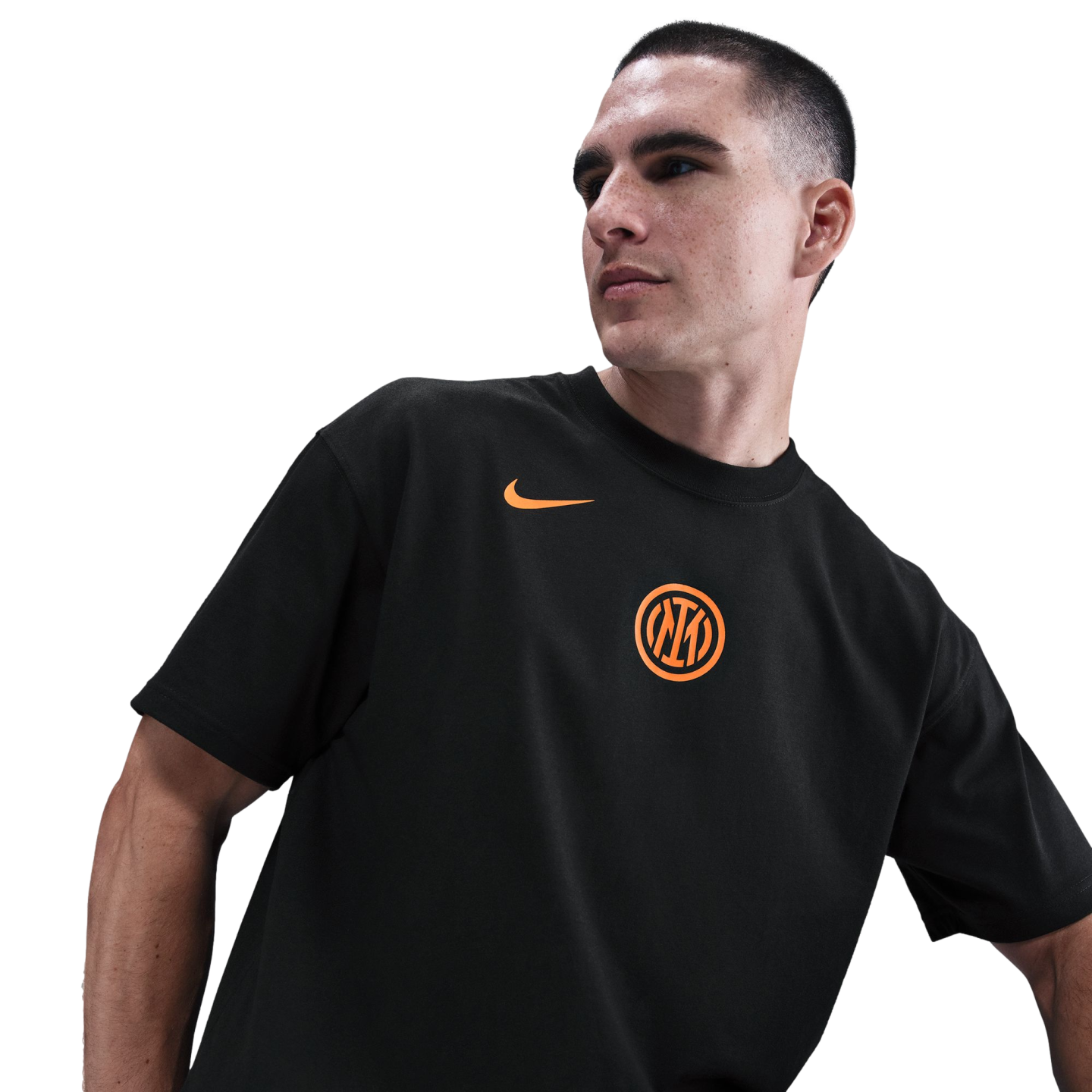A man wearing a black Inter Milan t-shirt with an orange Nike swoosh and club crest, looking to the side against a black background.