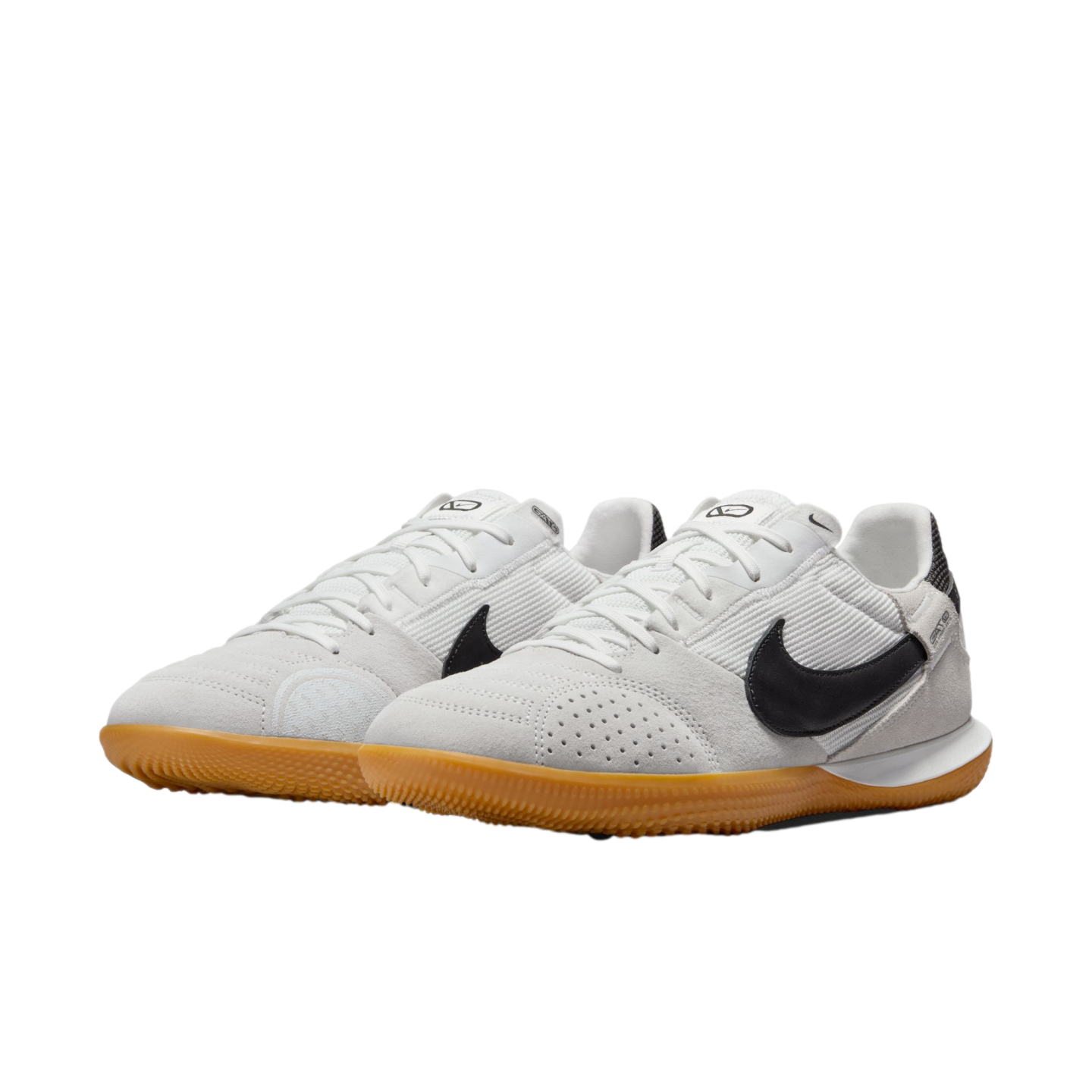 White and light grey Nike Street Gato sneakers with black Swooshes and gum rubber soles, shown from a three-quarter angle on a white background.