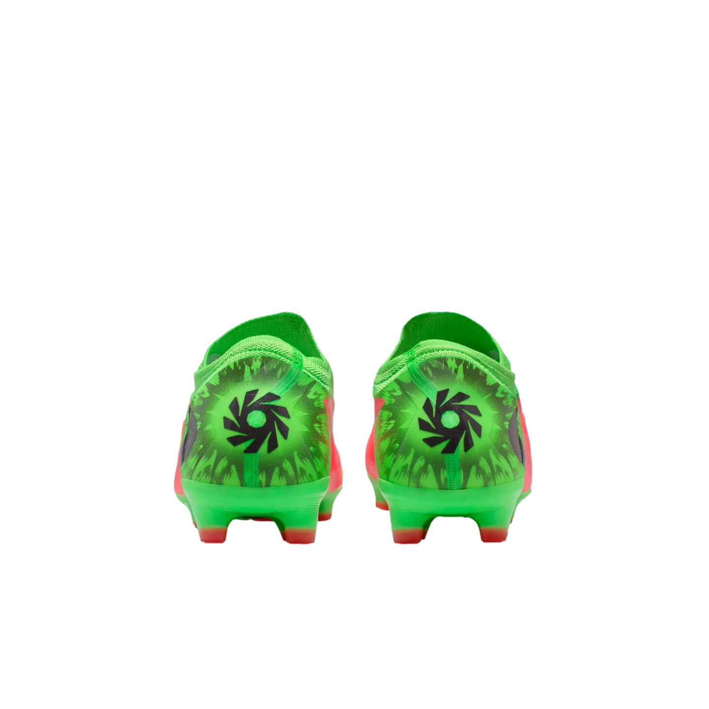 Rear view of a pair of neon green and orange soccer cleats, featuring a black circular graphic on the heels against a black background.