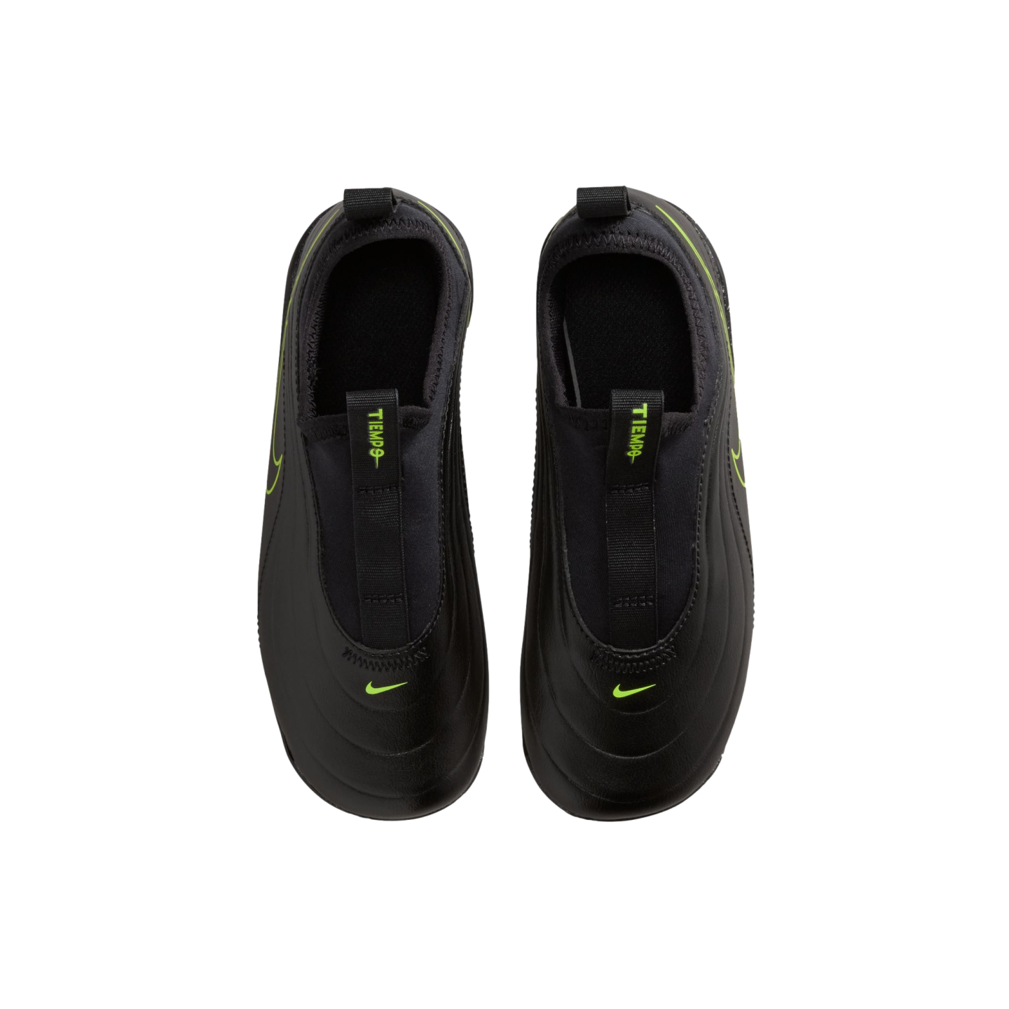 A top-down view of a pair of black Nike Tiempo slip-on athletic shoes against a solid black background. The matte black shoes feature vibrant neon green accents, including small Nike swooshes on the toes and "TIEMPO" text on the front pull tabs.