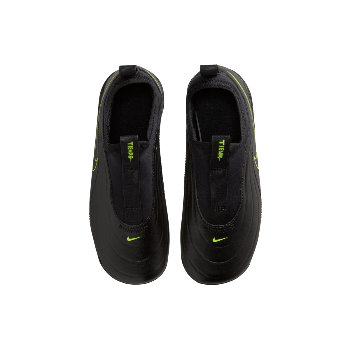 A top-down view of a pair of black Nike Tiempo slip-on athletic shoes against a solid black background. The matte black shoes feature vibrant neon green accents, including small Nike swooshes on the toes and "TIEMPO" text on the front pull tabs.