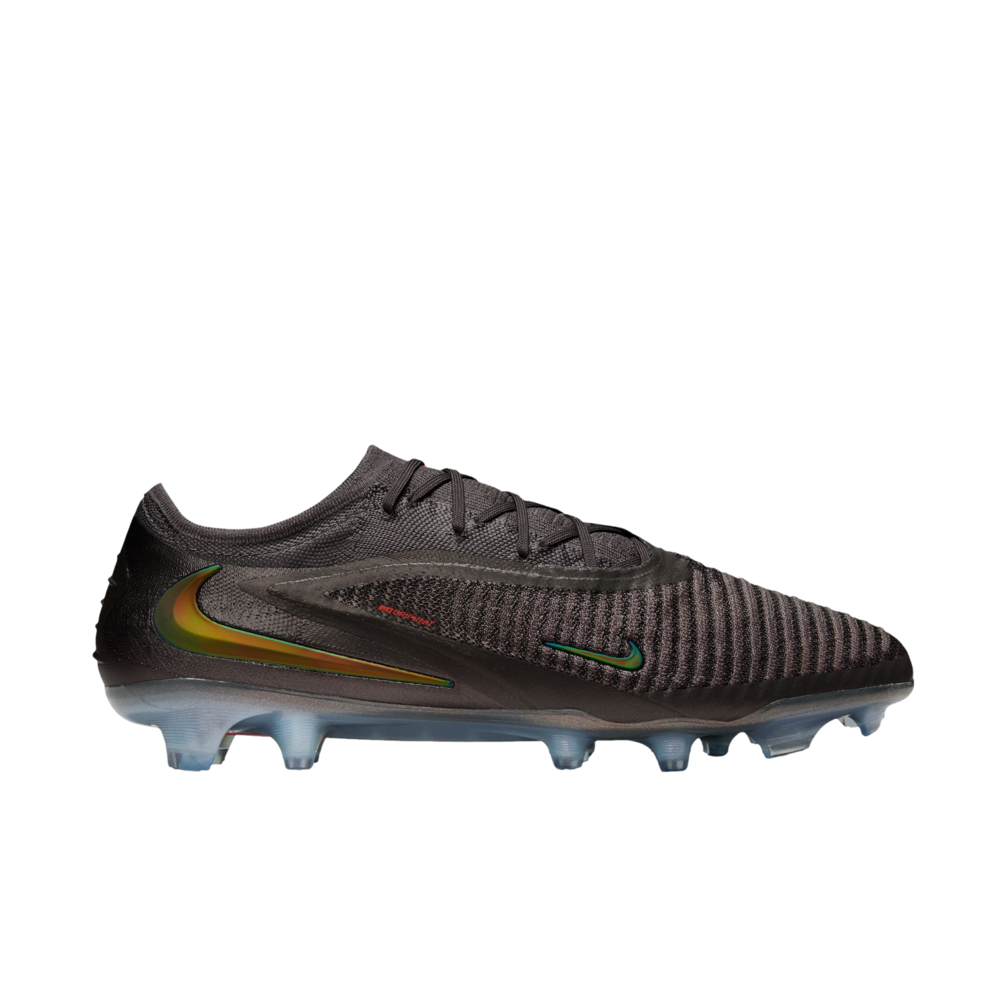 A side view of a dark charcoal Nike soccer cleat featuring iridescent green and gold swooshes and a textured, ribbed upper, set against a solid black background.