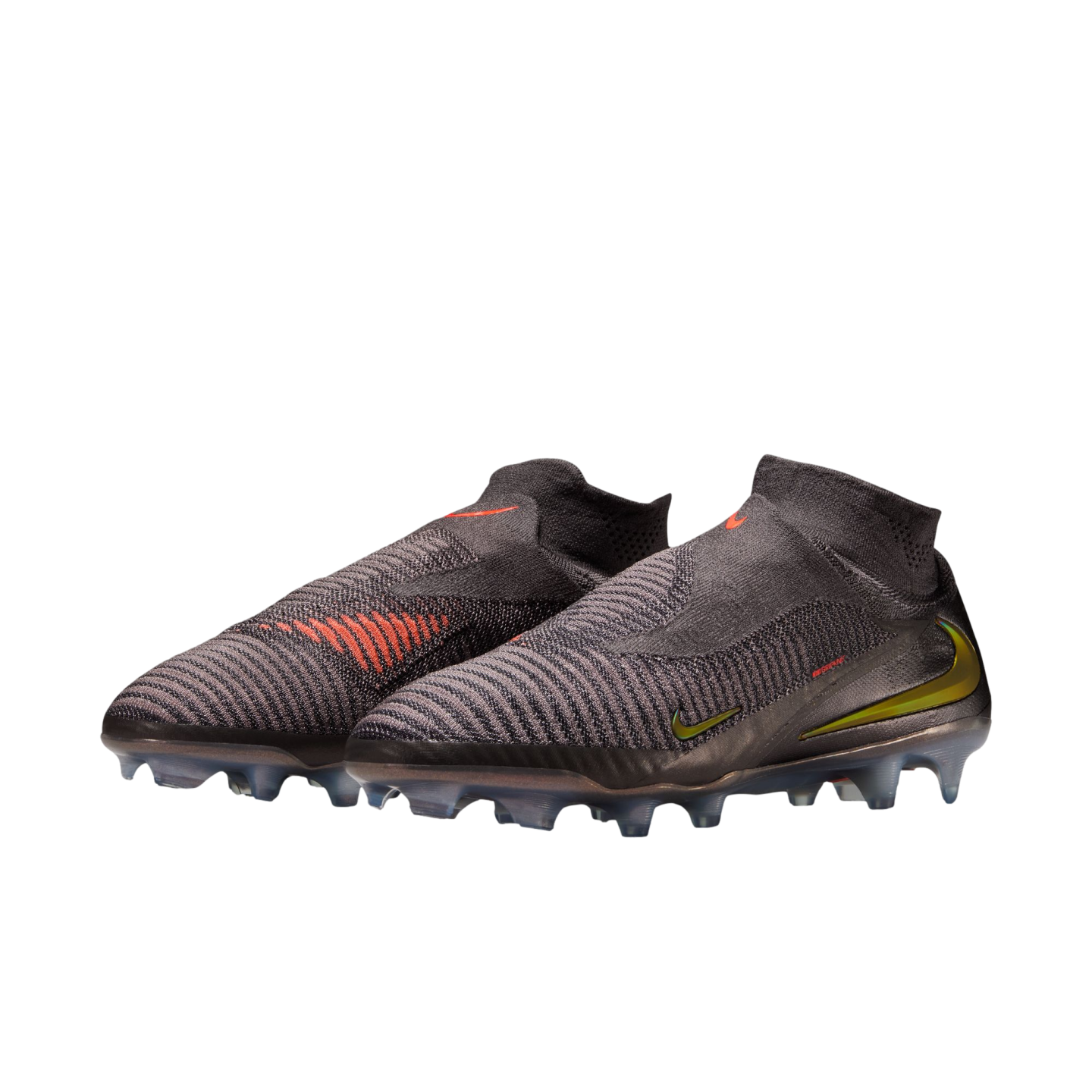 A pair of charcoal grey Nike laceless soccer cleats with a high-top knitted collar, featuring orange and lime green accents against a solid black background.