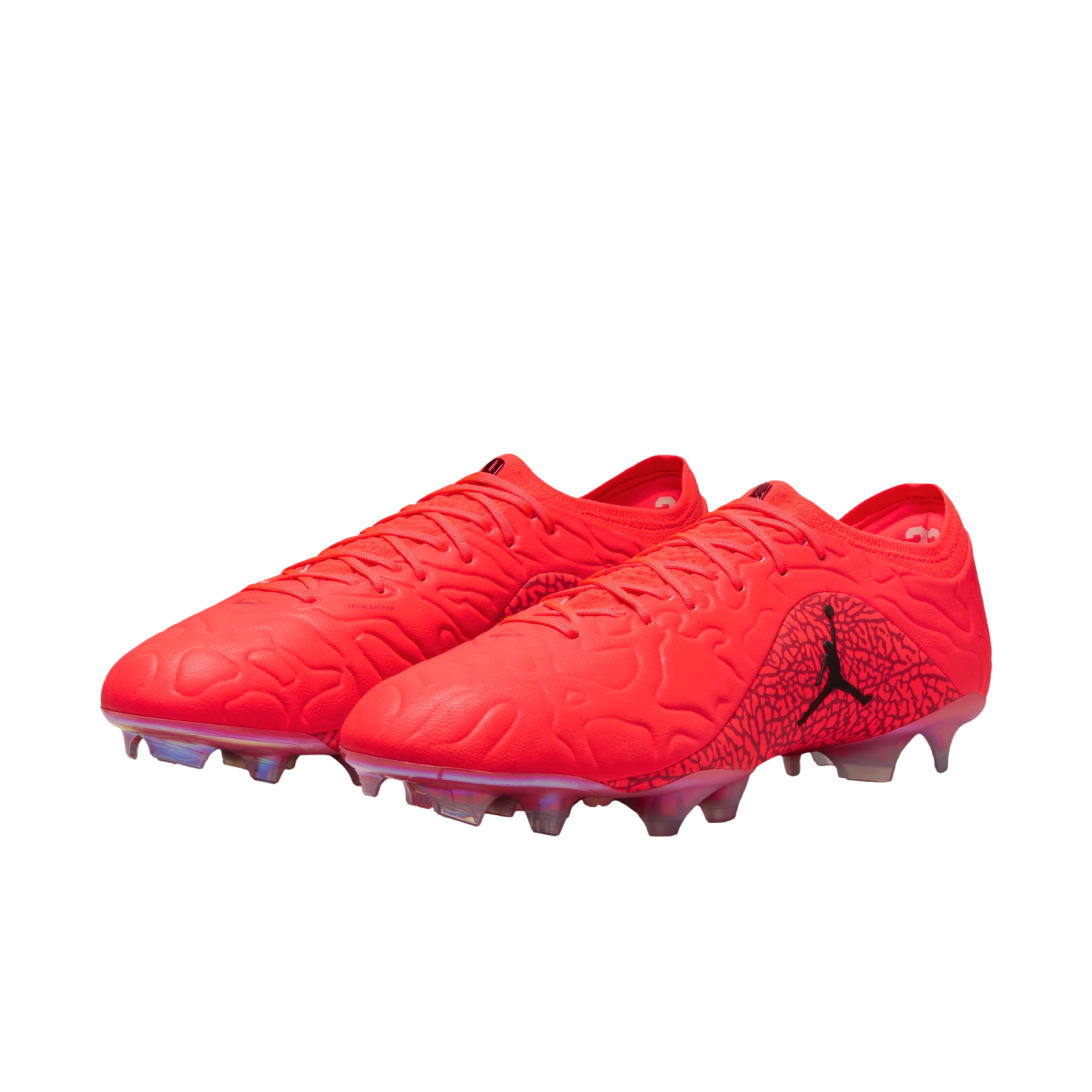 A pair of vibrant red Jordan soccer cleats featuring a textured upper and a black Jumpman logo, shown against a solid black background.