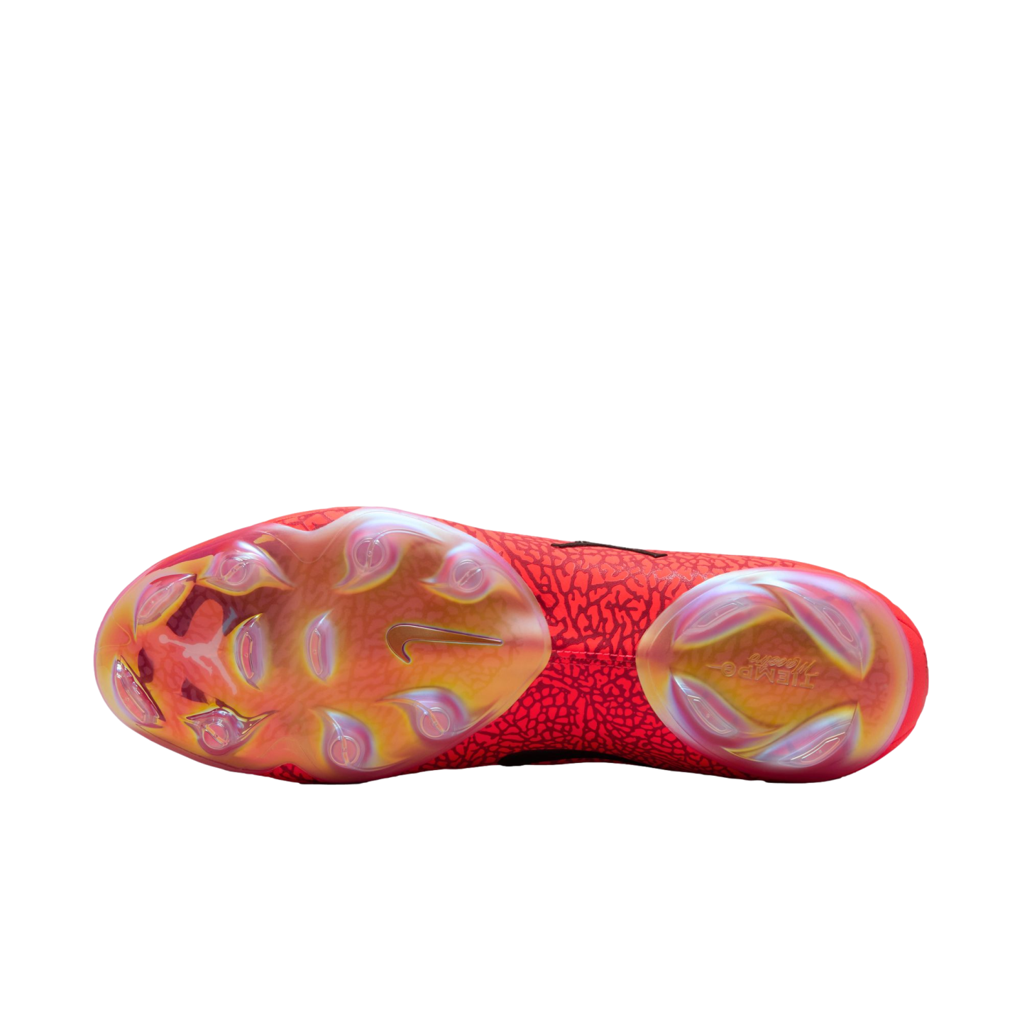 Bottom view of a red Nike Tiempo soccer cleat showing its iridescent soleplate, golden Nike swoosh, and stud pattern against a black background.