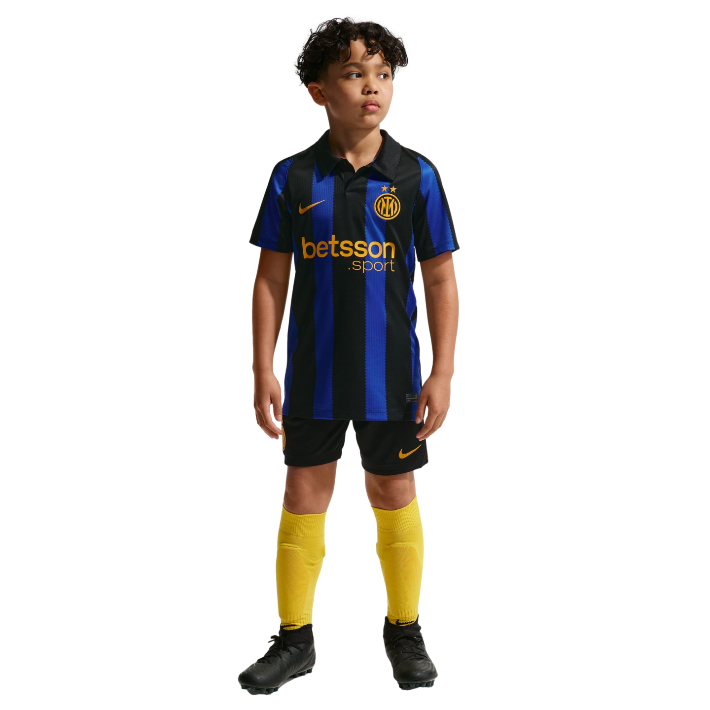 A young boy posing in a blue and black striped Inter Milan soccer jersey, black shorts, yellow socks, and black cleats on a plain white background.