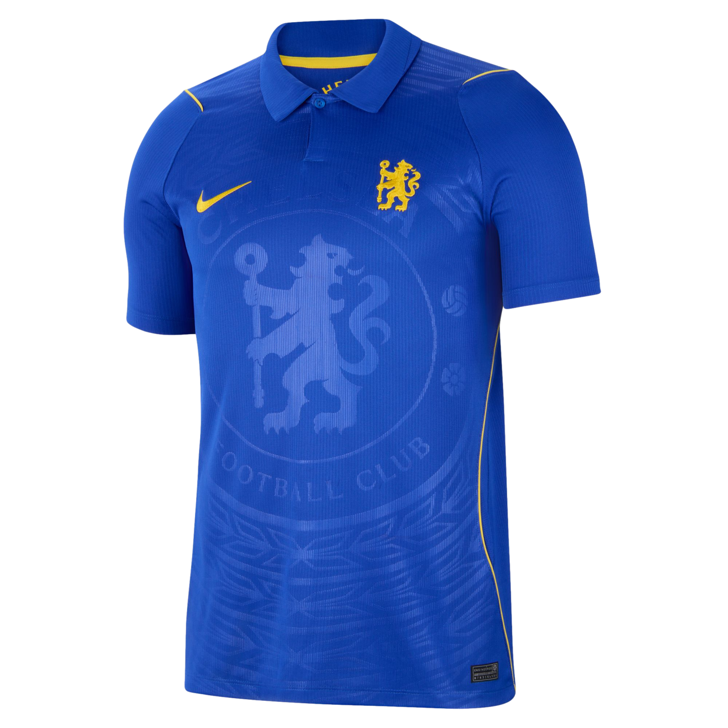 A blue Nike Chelsea FC short-sleeve polo jersey featuring a yellow club crest, yellow Nike swoosh, and a large tonal embossed Chelsea crest in the center.