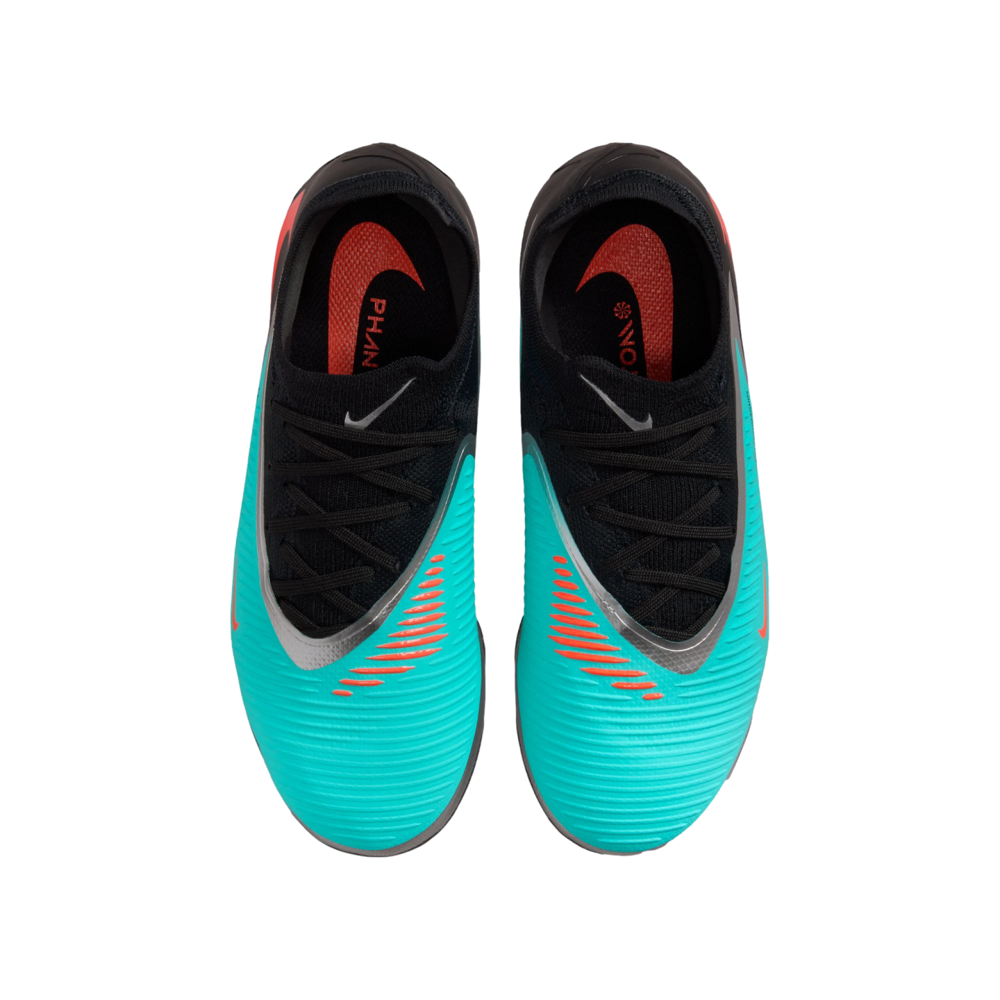 Overhead view of teal and black Nike Phantom soccer cleats with orange accents and black laces against a solid black background.