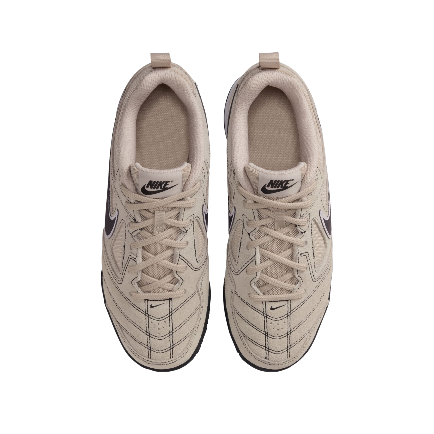 A top-down view of a pair of beige Nike sneakers on a black background, featuring suede and mesh panels, matching laces, and black branding details.
