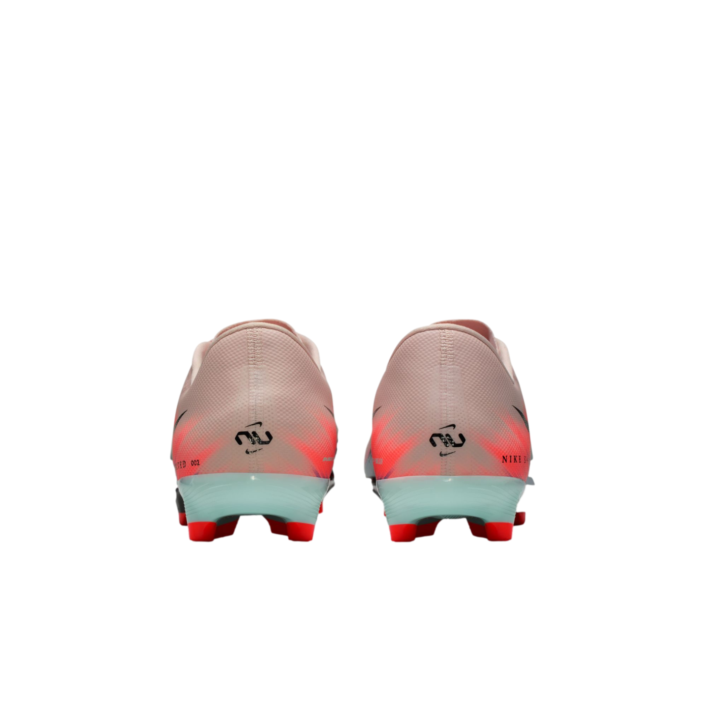 Rear view of pink and orange Nike soccer cleats with light blue heel counters and red studs against a black background.