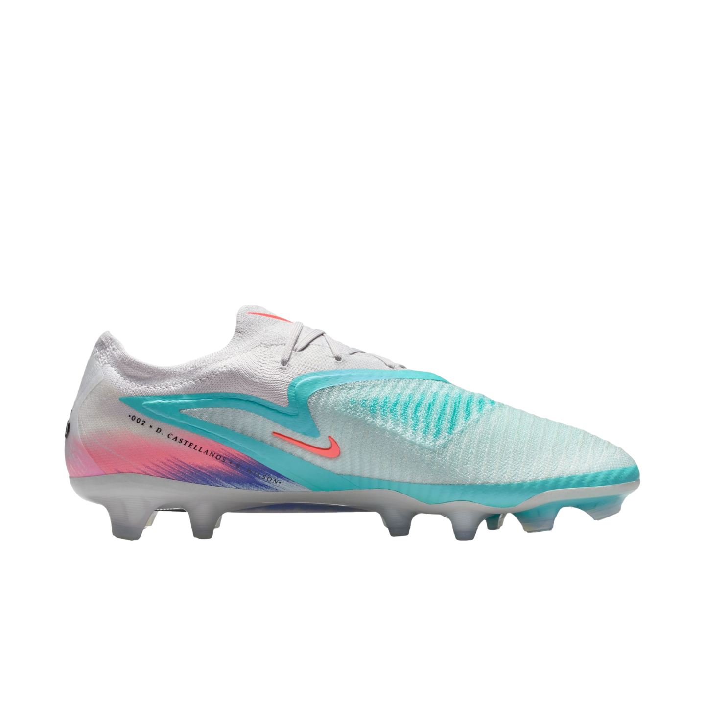 Profile view of a Nike Phantom GX soccer cleat with a white upper, teal and pink accents, and translucent studs, set against a black background.