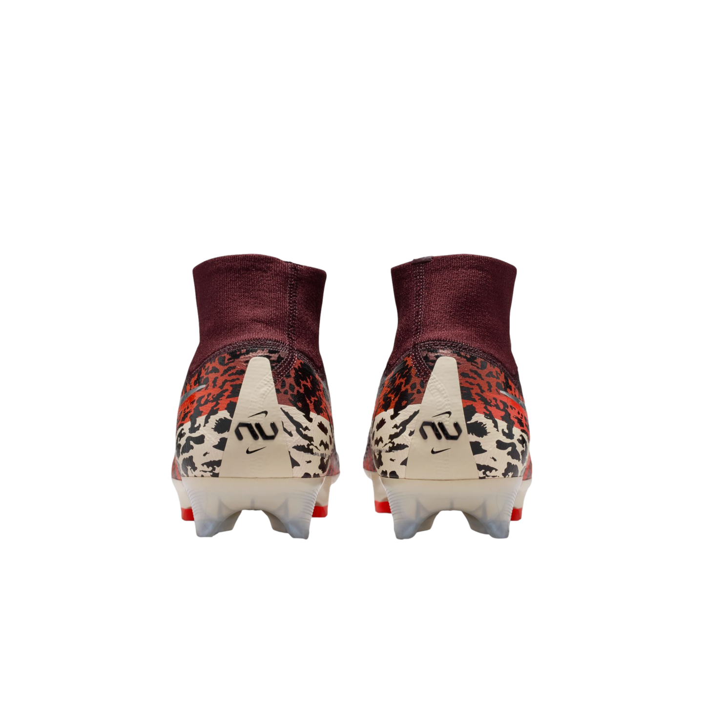 A rear view of a pair of Nike soccer cleats featuring high-top maroon ankle collars and animal print patterns in orange, black, and cream. Each cream-colored heel counter displays a stylized "NU" logo and a small Nike swoosh.