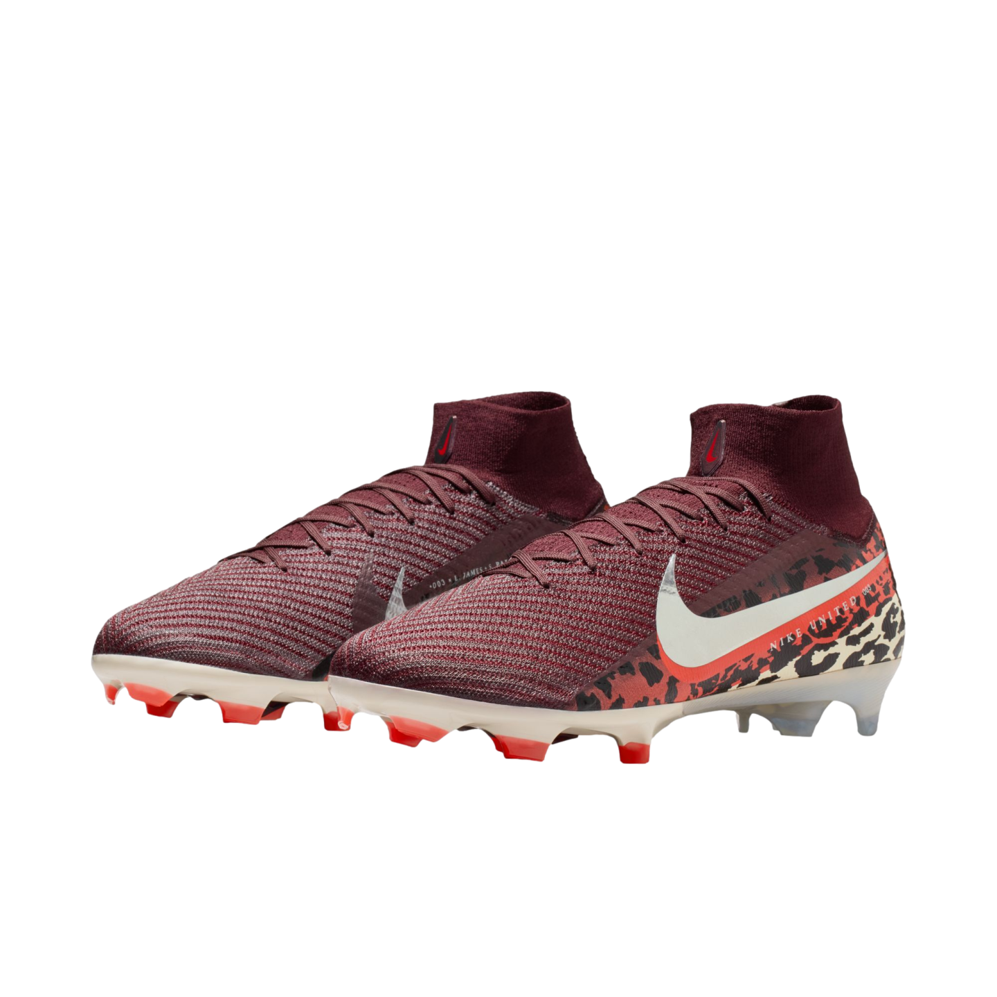 A pair of maroon Nike soccer cleats with a knitted texture and high-top collar, featuring a white swoosh and a bold animal print pattern on the heel, set against a solid black background.