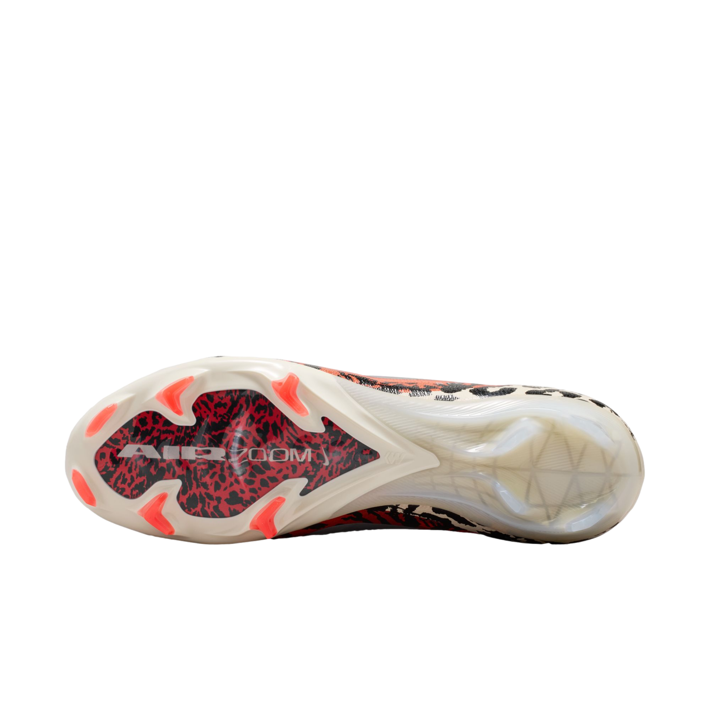 A bottom-up view of a soccer cleat against a black background, showcasing a white sole with a red and black graphic under the forefoot labeled "AIR ZOOM." The shoe features bright orange studs and a translucent heel section.