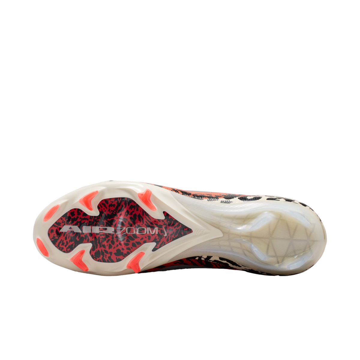 A bottom-up view of a soccer cleat against a black background, showcasing a white sole with a red and black graphic under the forefoot labeled "AIR ZOOM." The shoe features bright orange studs and a translucent heel section.