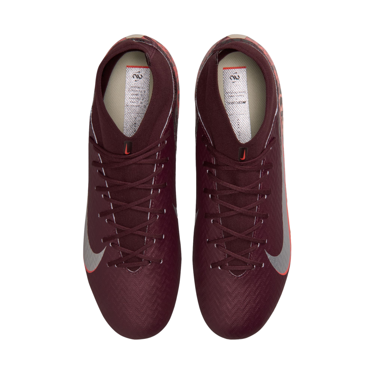 A top-down view of a pair of deep maroon Nike soccer cleats with silver swooshes and high-top ankle collars, set against a solid black background.