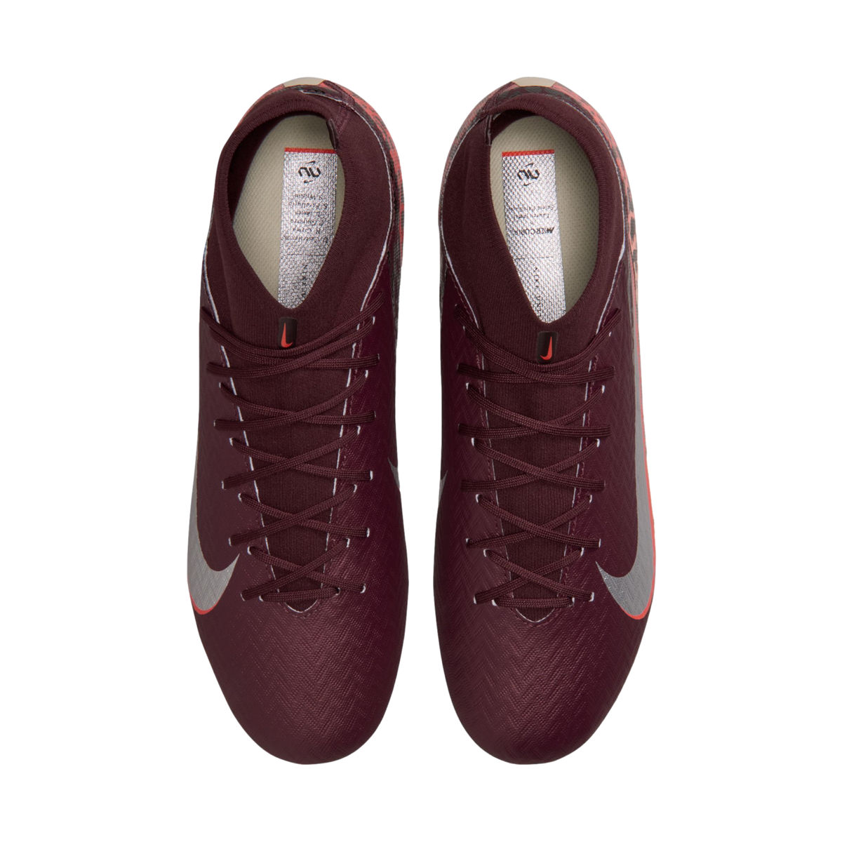 A top-down view of a pair of deep maroon Nike soccer cleats with silver swooshes and high-top ankle collars, set against a solid black background.