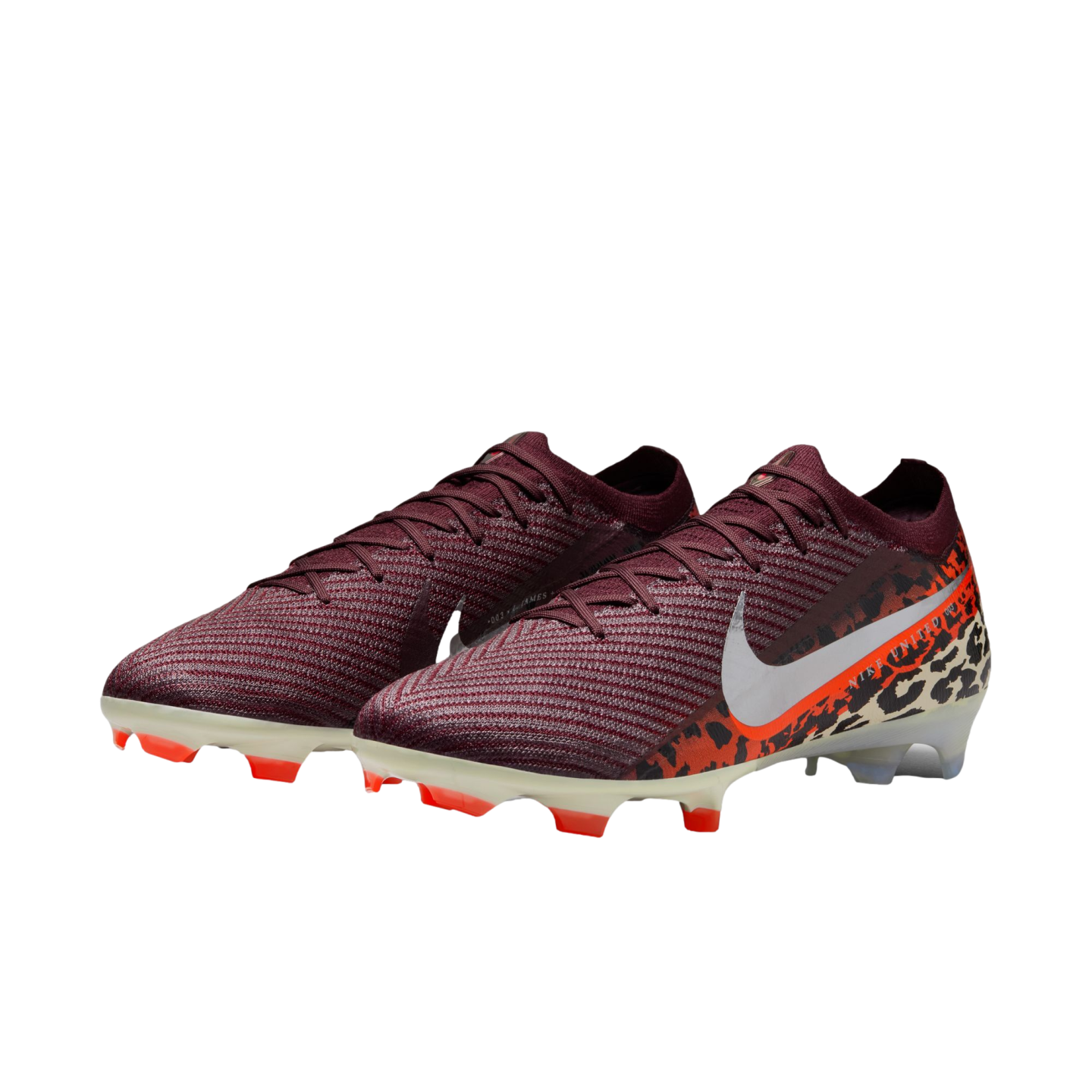 A pair of Nike Mercurial soccer cleats featuring a dark maroon knit upper that transitions into an orange and black leopard print pattern at the heel. A large white Nike swoosh is prominent on the side, and the cream-colored soleplate has bright orange st