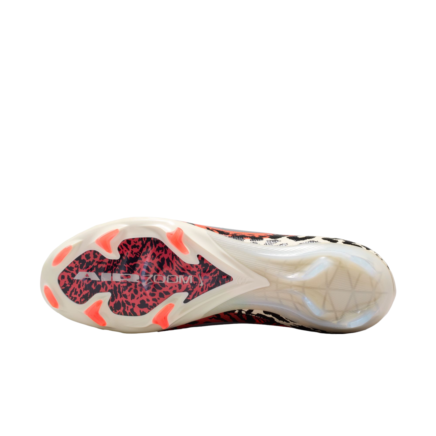 A close-up, bottom view of a soccer cleat's outsole against a solid black background. The cream-colored sole features six bright red-orange studs in the forefoot and a central red and black leopard-print pattern with white "AIR ZOOM" text. The heel sectio
