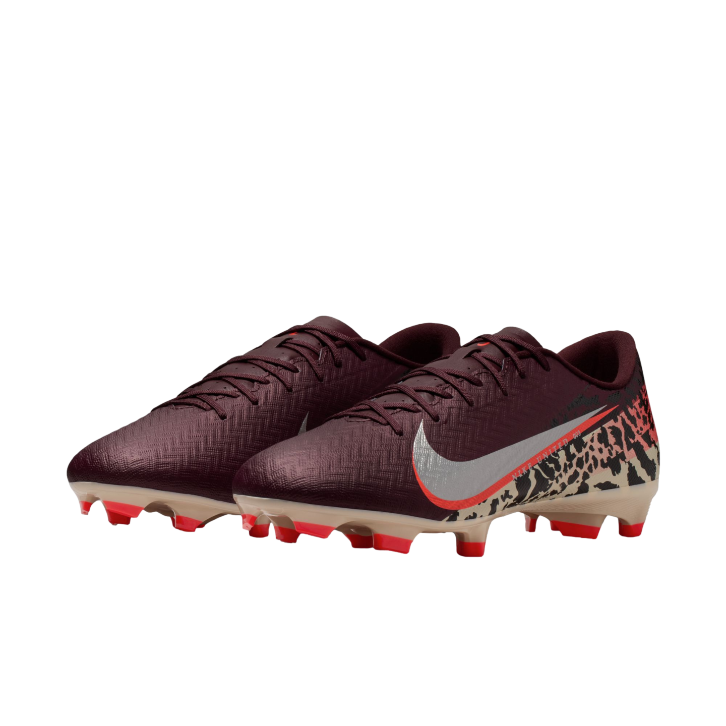 A pair of burgundy Nike soccer cleats against a black background. The right shoe displays a silver Nike swoosh with an orange border and a beige leopard print pattern on the heel. The sole is tan with vibrant orange studs.