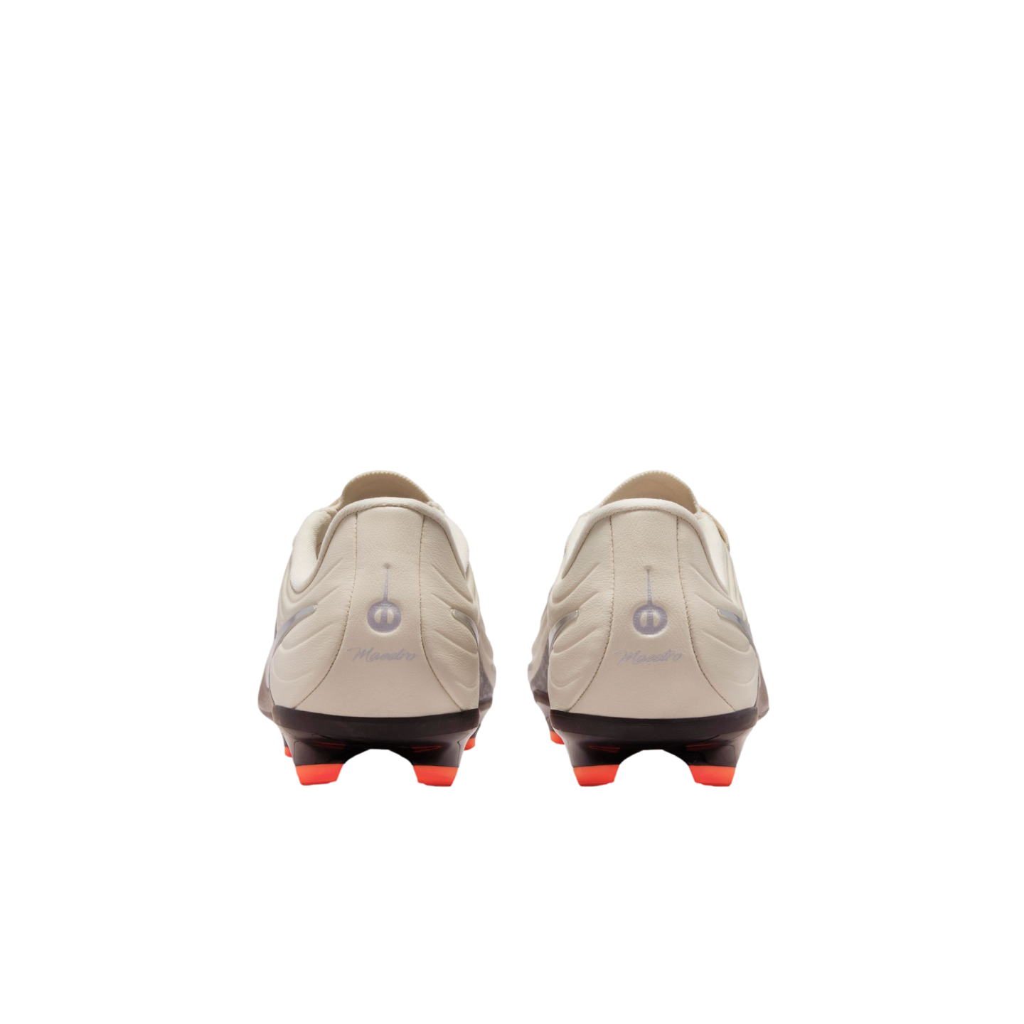 A rear view of a pair of off-white soccer cleats against a black background, featuring black soleplates with bright orange studs and "Maestro" scripted on each heel.