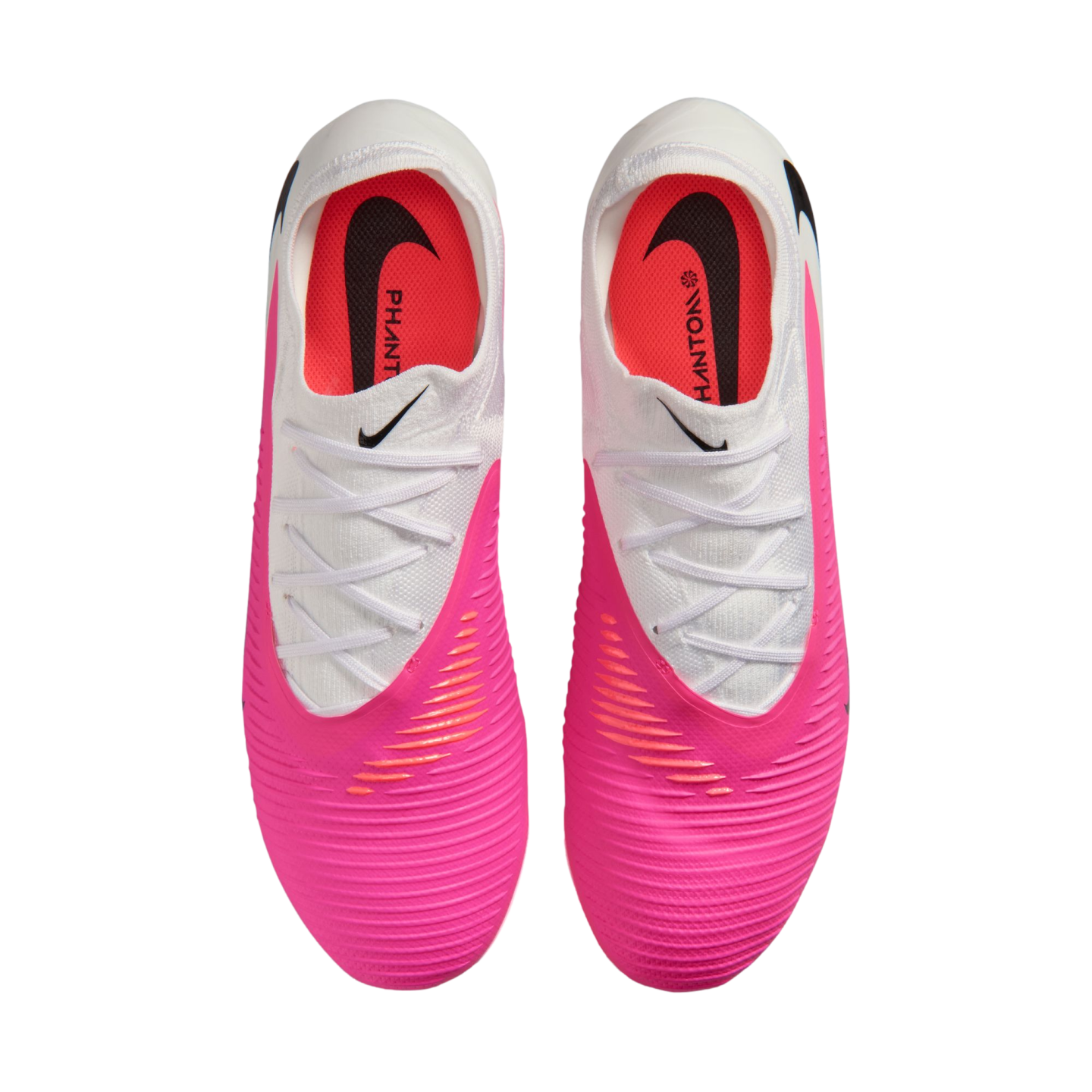 Top-down view of pink and white Nike Phantom soccer cleats on a white background.