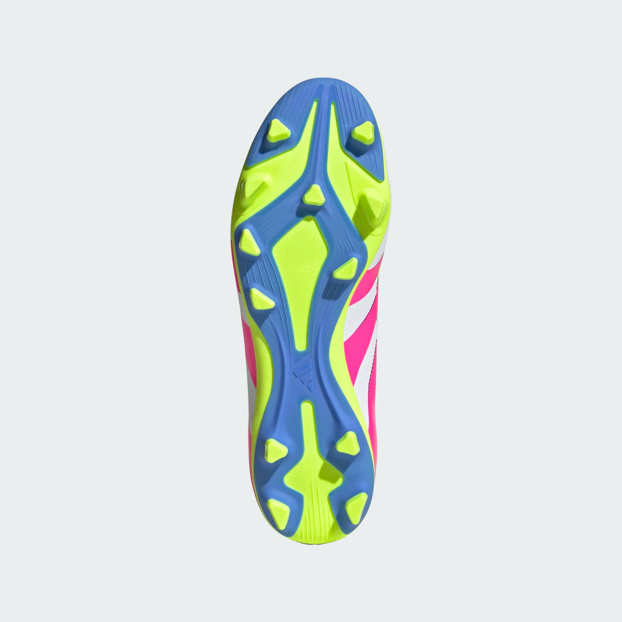Bottom view of an Adidas soccer cleat with a neon yellow and blue soleplate, featuring multi-directional studs and pink accents on the upper.