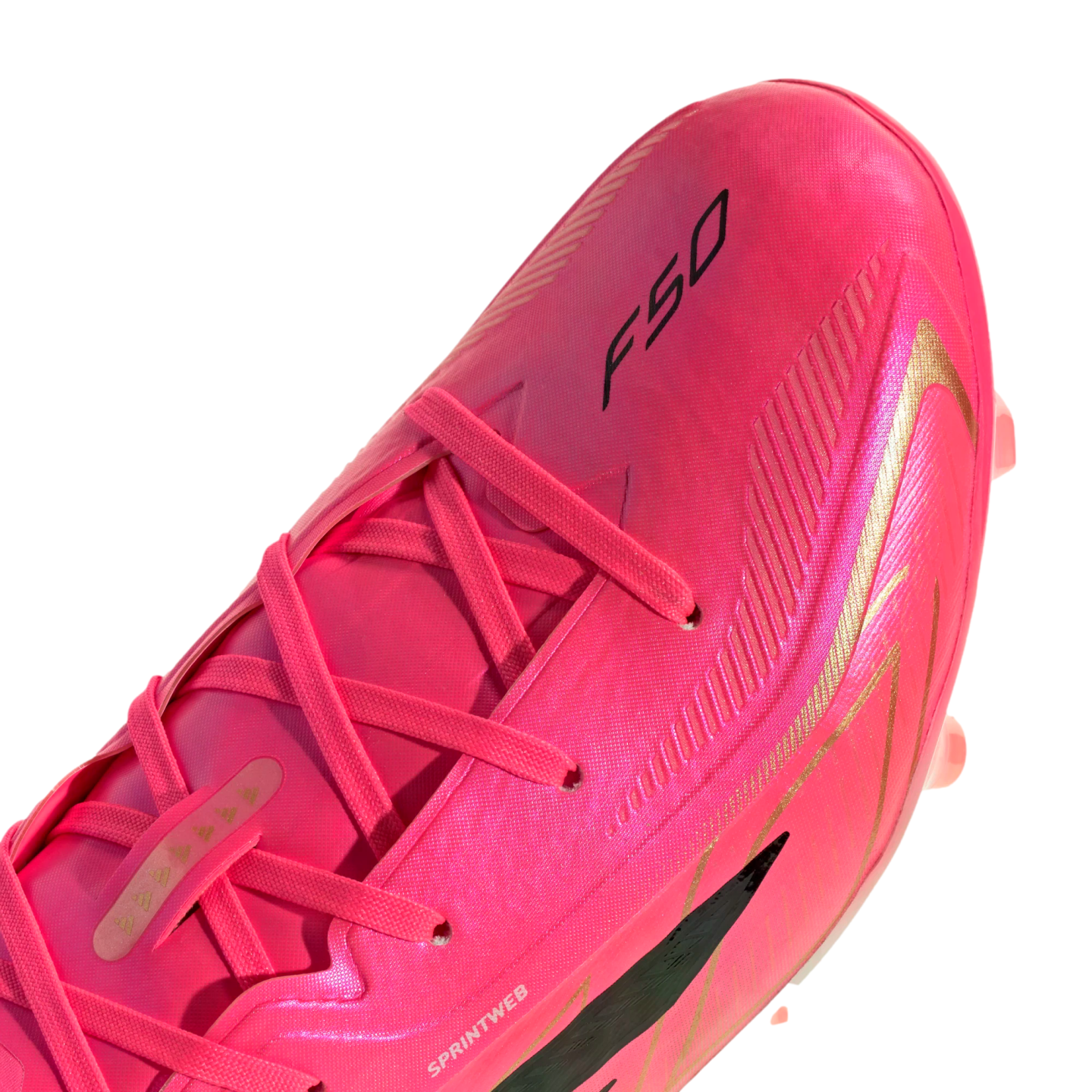 Close-up of a bright pink soccer cleat with gold accents and the black "F50" logo on its upper. The cleat features pink laces and is shown against a white background.