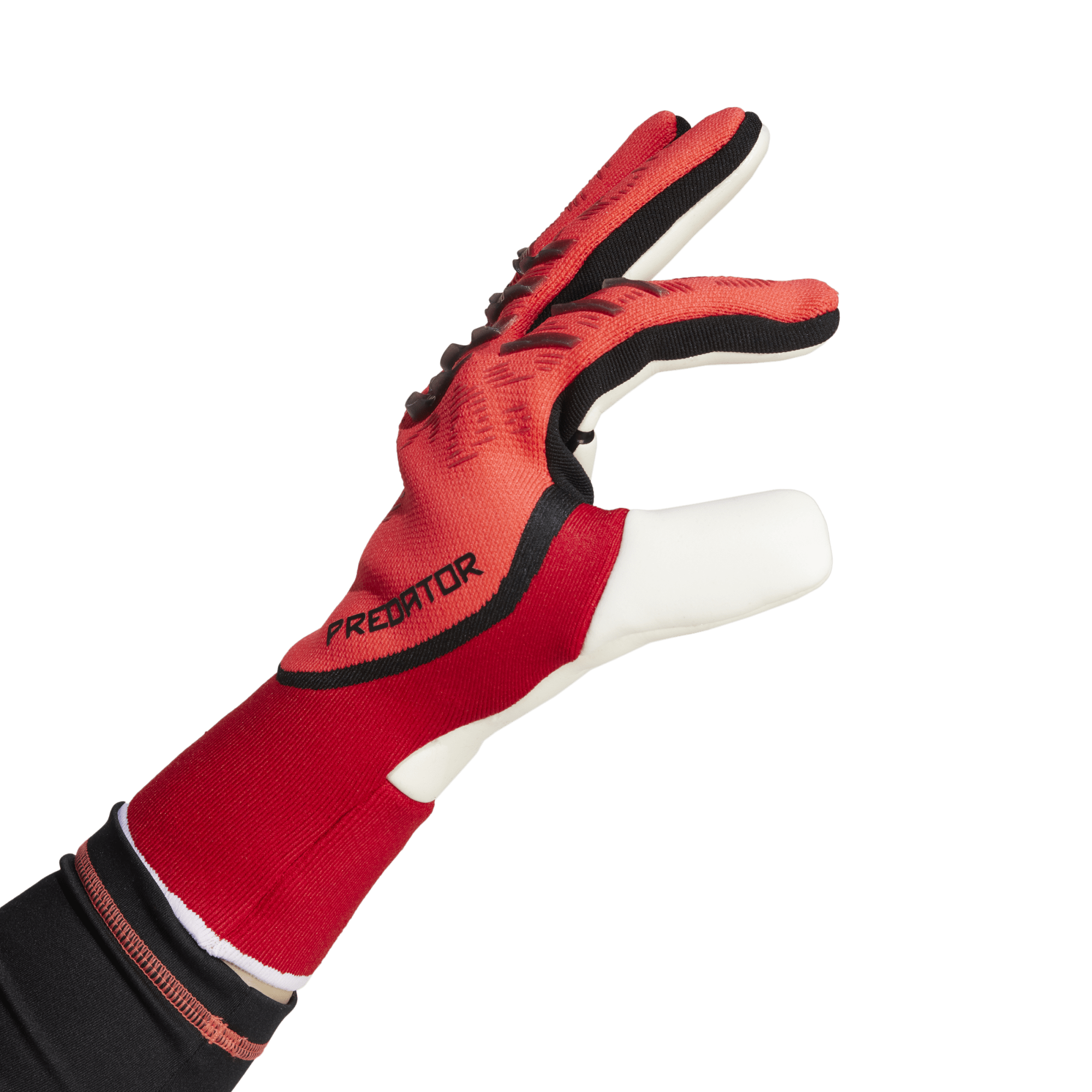 Red and black Adidas Predator goalkeeper glove shown from a side profile against a solid green background.