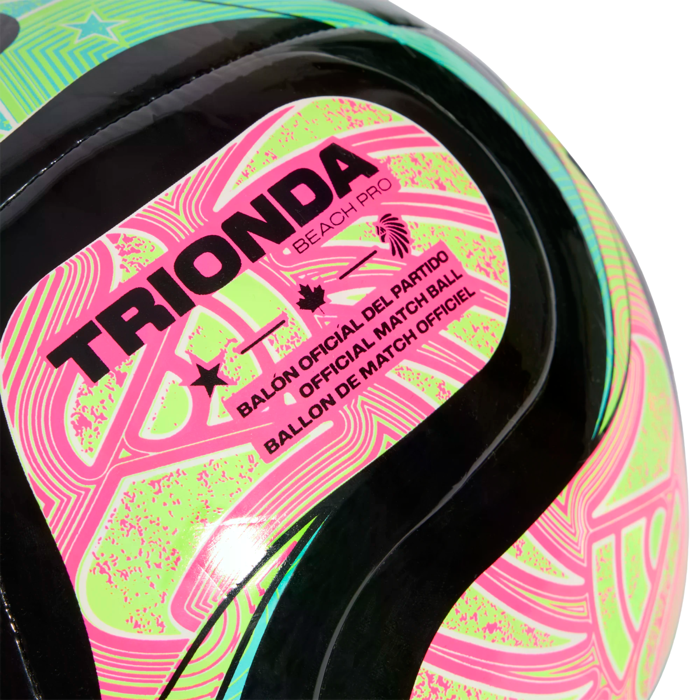 Close-up of a Trionda Beach Pro official match ball featuring neon pink and green patterns on a black surface.
