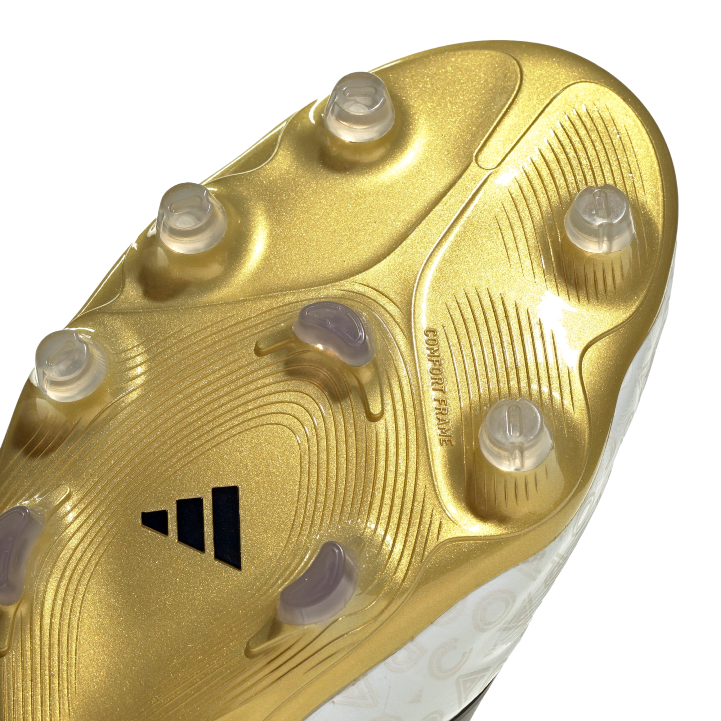 Close-up of a metallic gold Adidas soccer boot soleplate with clear studs and textured patterns.