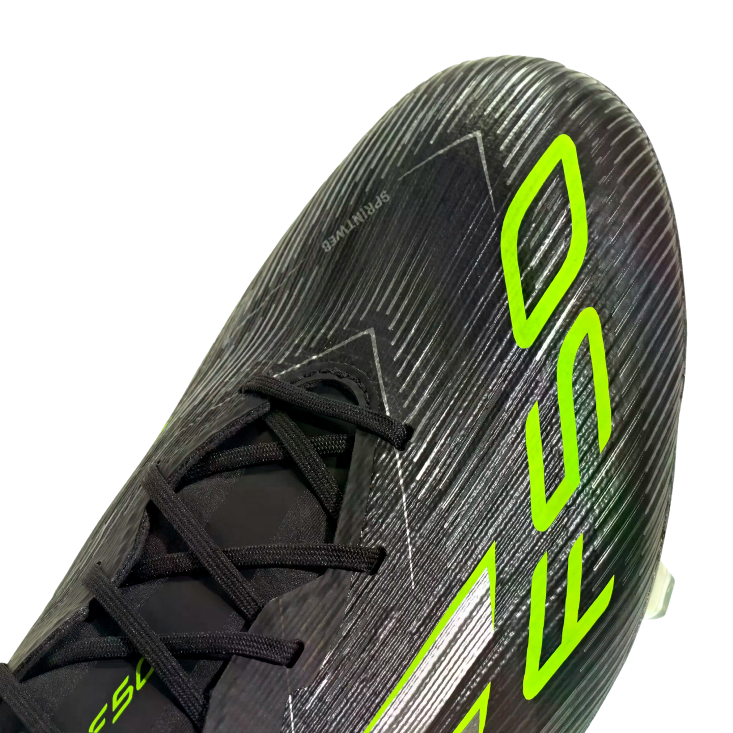 Close-up of a black soccer cleat with neon green "F50" branding and a textured, striped upper.