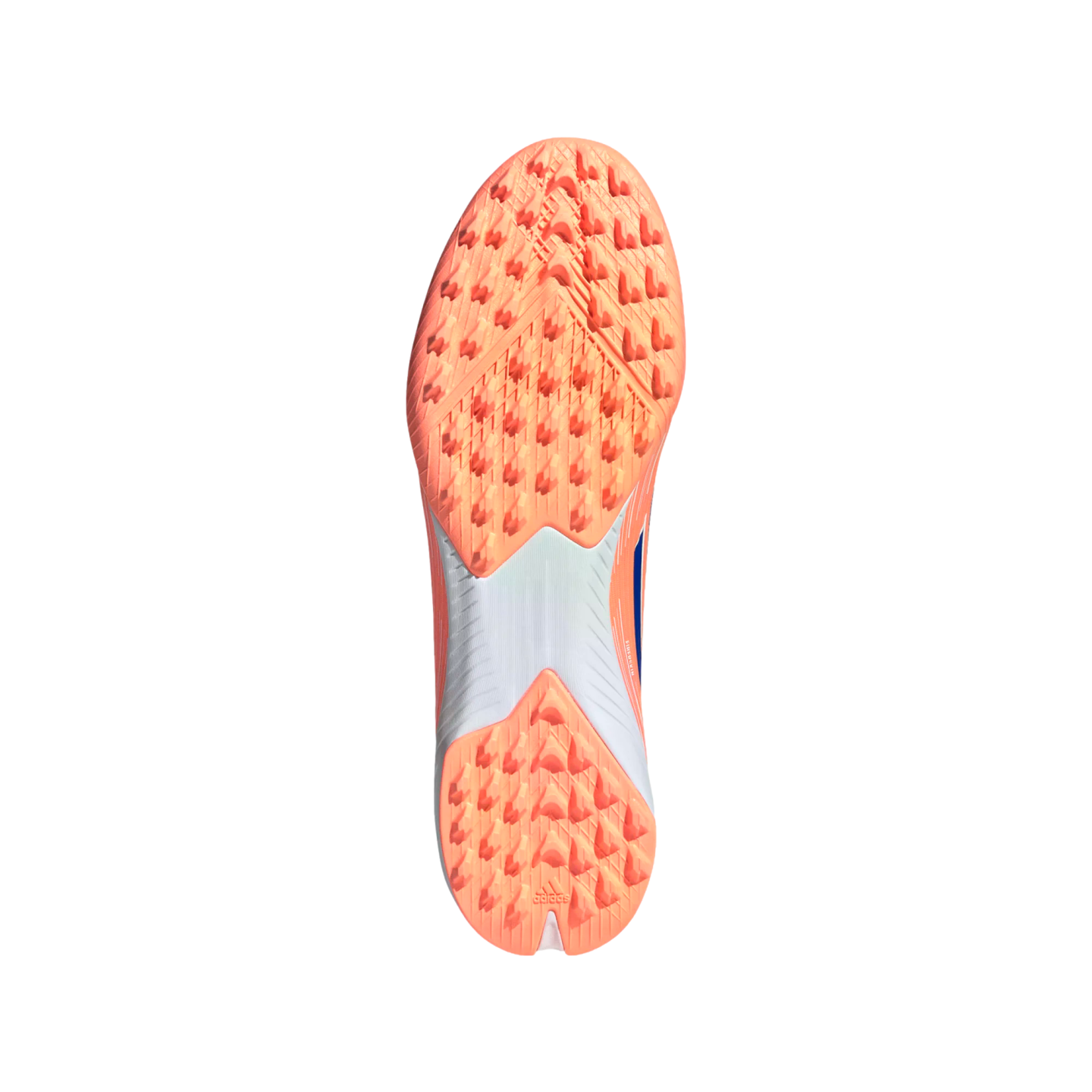 The outsole of a pinkish-orange Adidas turf shoe with numerous triangular cleats and a white midfoot section, centered on a black background.