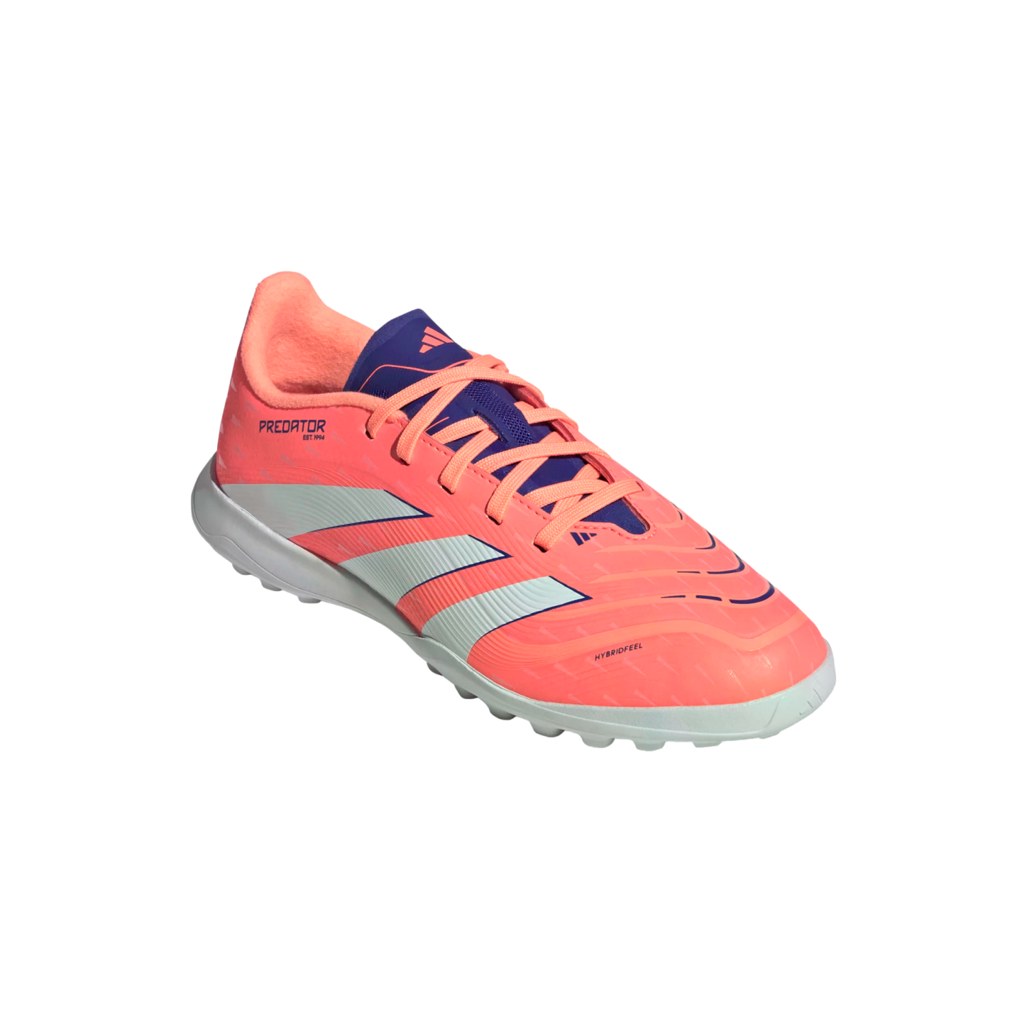 A coral pink Adidas Predator turf soccer shoe with three white stripes and purple accents, angled against a solid black background.