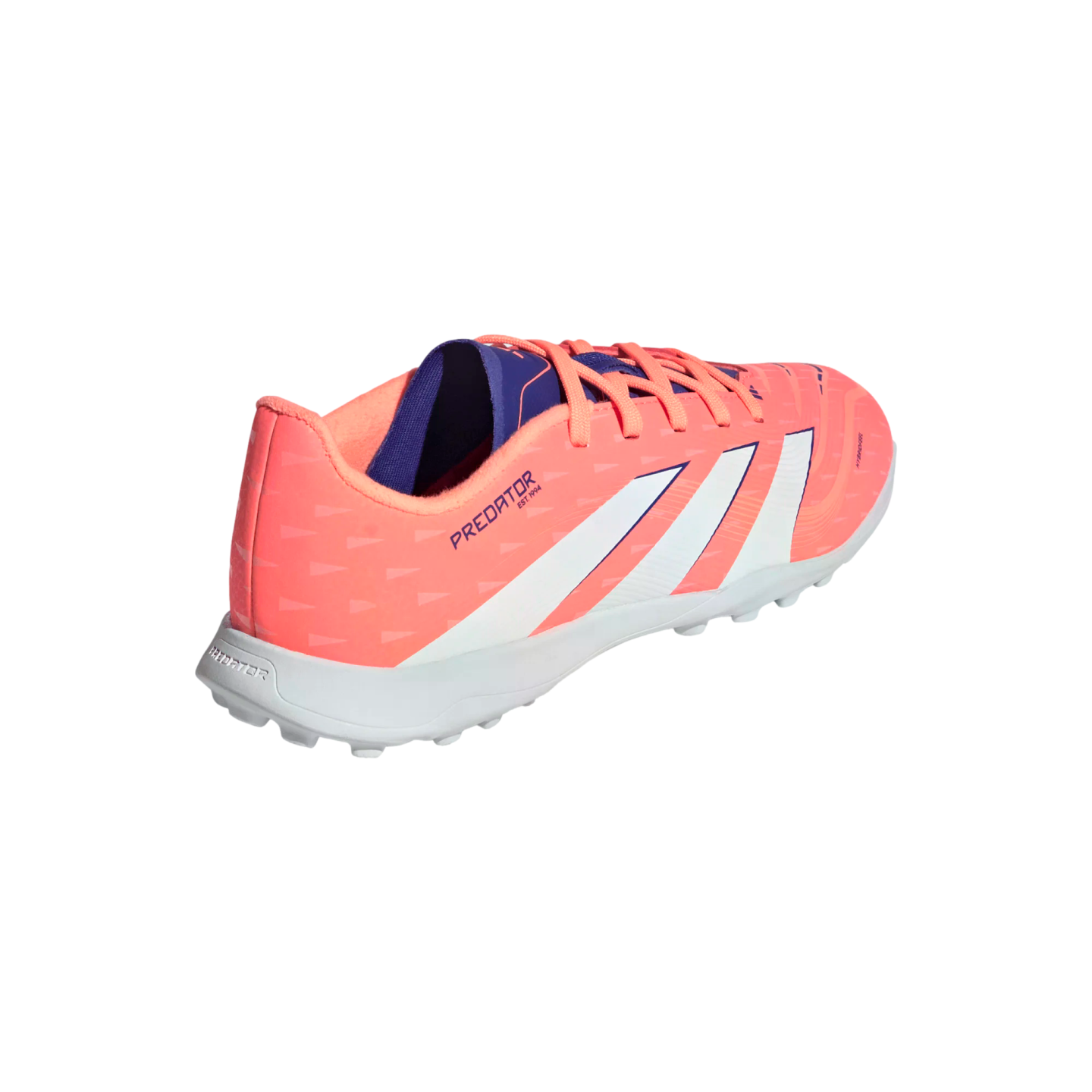 A salmon pink and white Adidas Predator turf soccer shoe, shown from a rear three-quarter angle against a solid black background.
