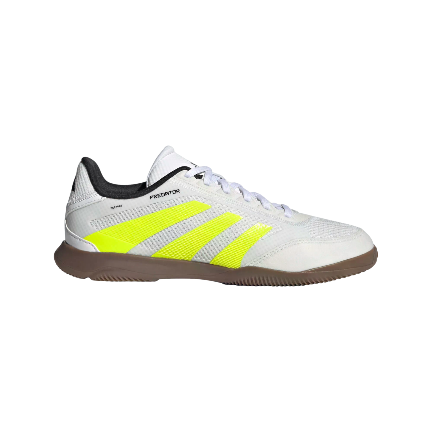 Side profile of a white Adidas Predator indoor soccer shoe with three neon yellow stripes, a black collar, and a brown rubber sole on a black background.