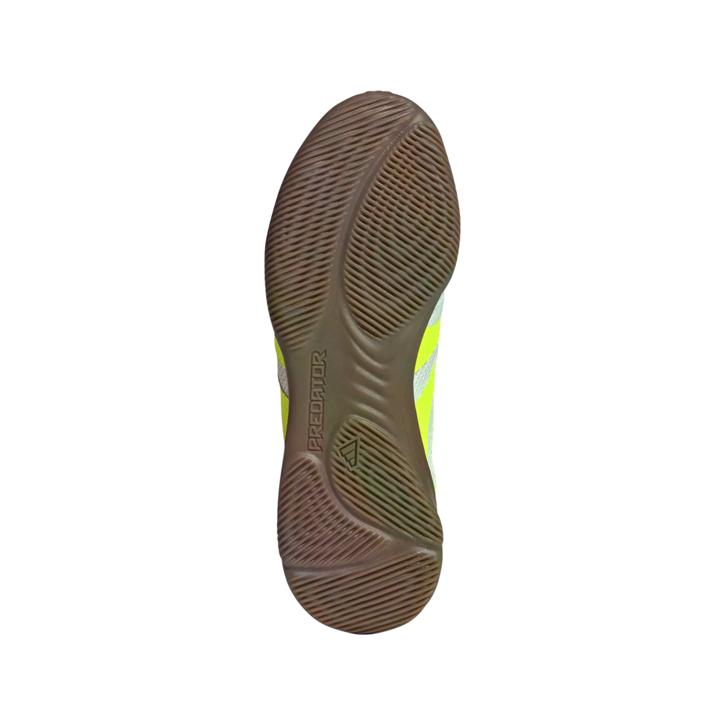 The brown gum rubber outsole of an Adidas Predator indoor soccer shoe featuring textured grip patterns, centered on a black background.