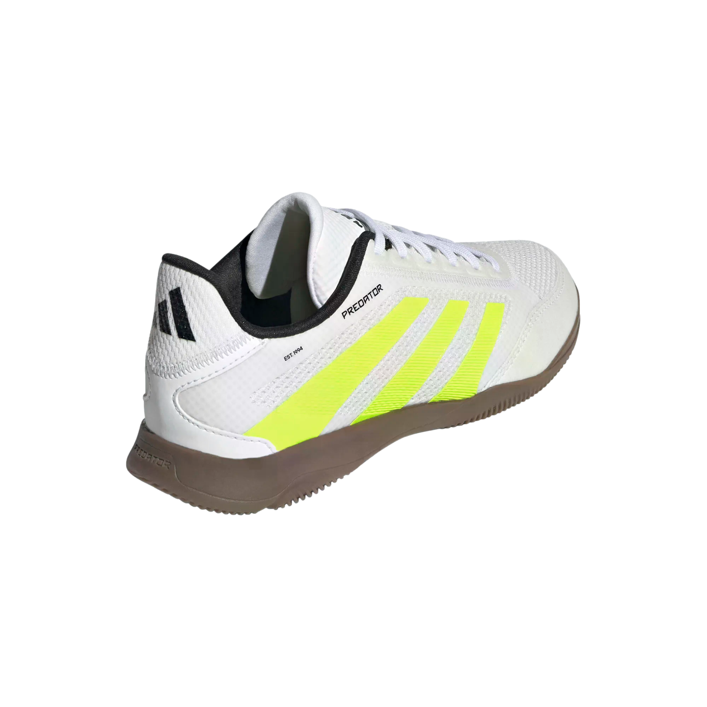 A rear-quarter view of a white Adidas Predator indoor soccer shoe featuring three neon yellow stripes and a brown gum sole, set against a solid black background.