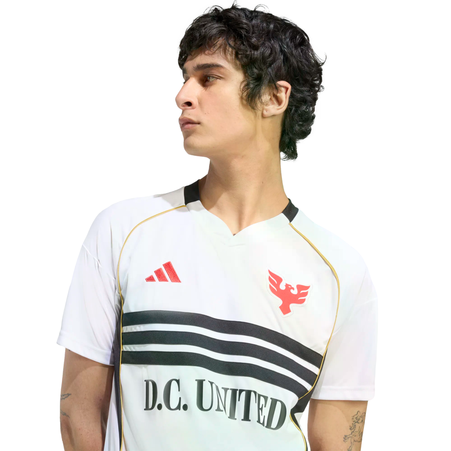 A man in a white D.C. United jersey with black stripes and red logos, looking away in profile against a black background.