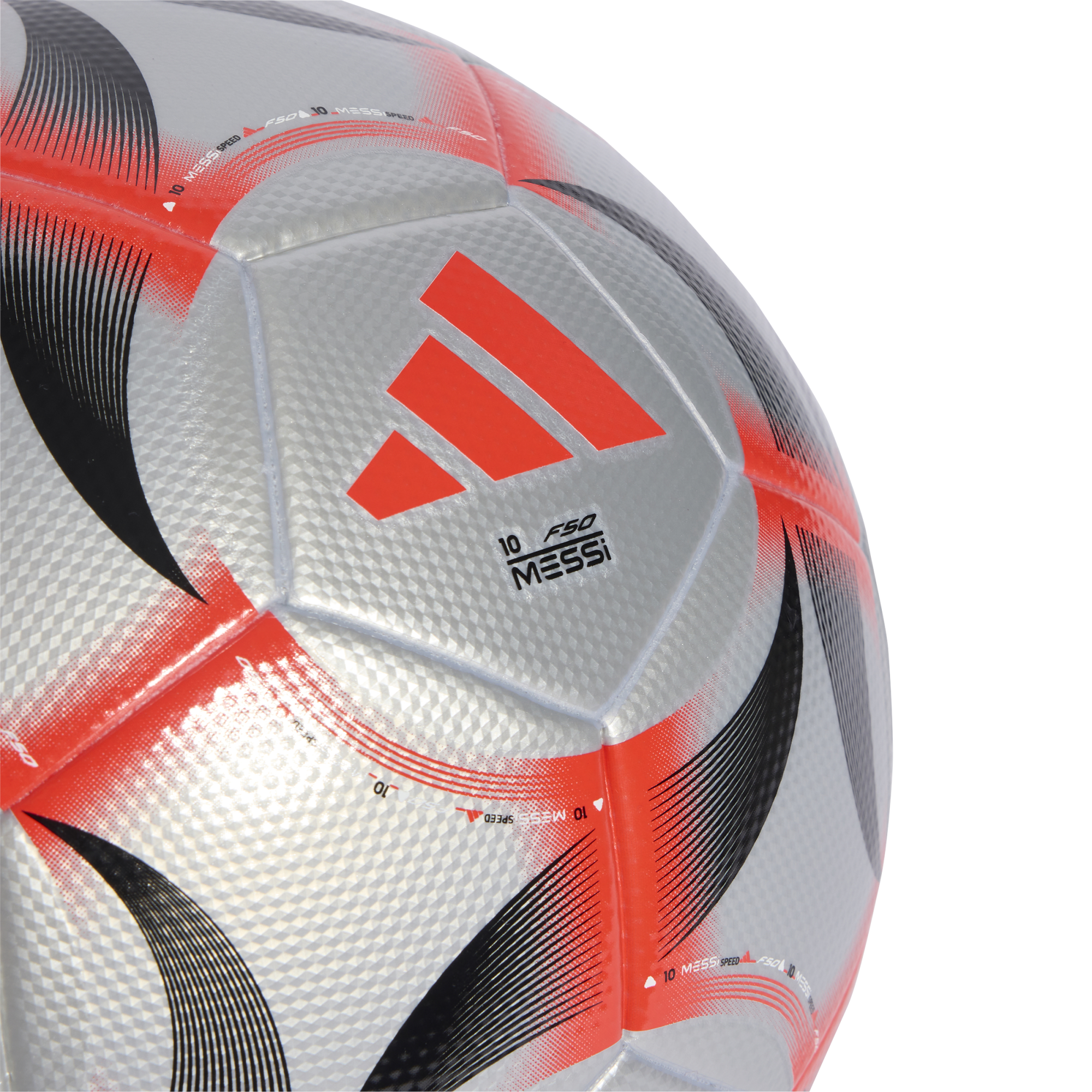Close-up of a silver Adidas F50 Messi soccer ball with orange and black graphics and a textured diamond pattern on its panels.