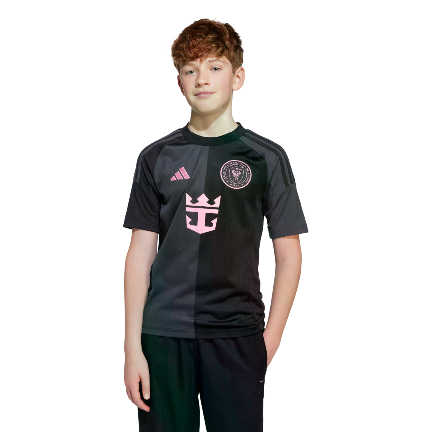A young boy with reddish hair wearing a black and charcoal Inter Miami soccer jersey.