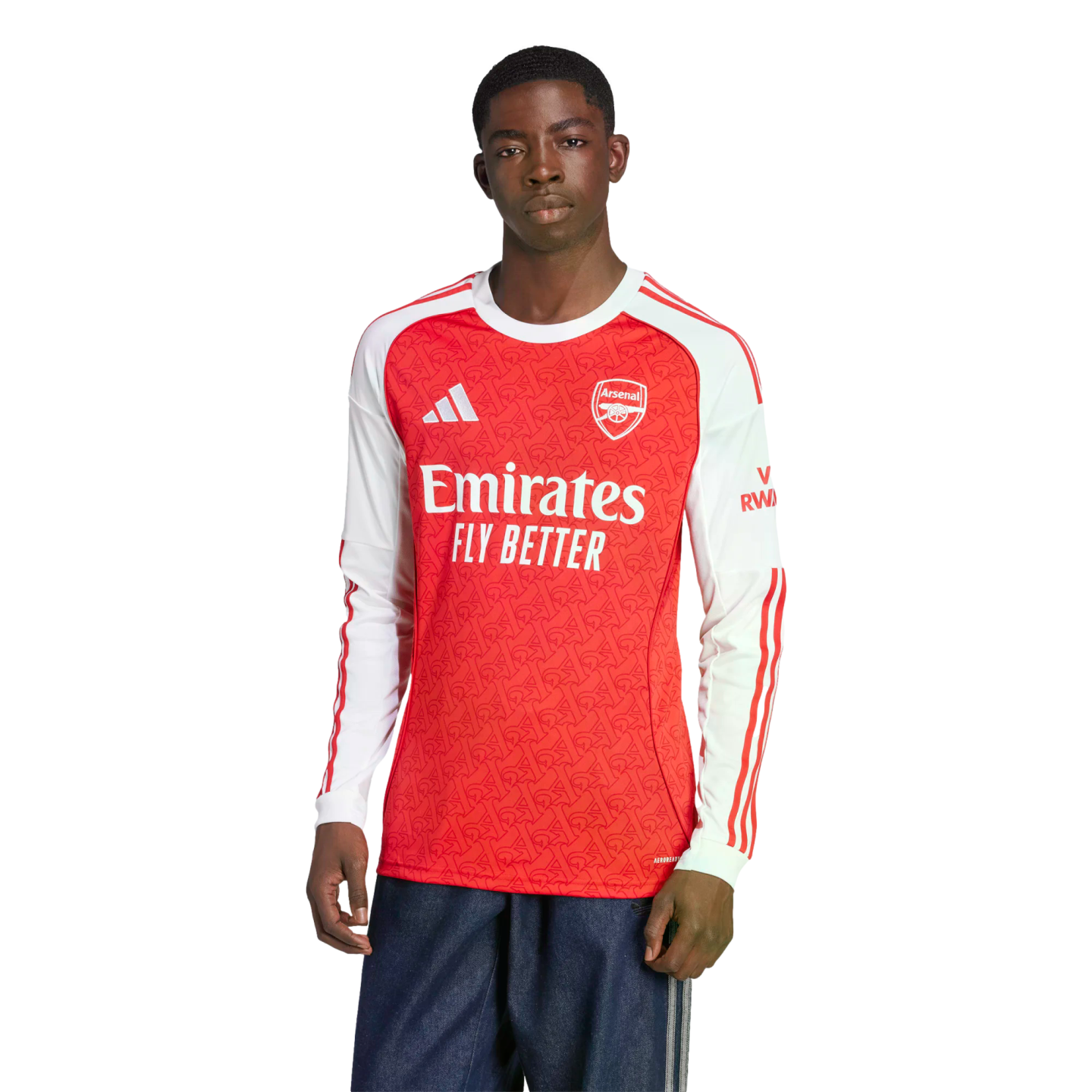 A man models a long-sleeved red and white Arsenal FC soccer jersey with the Emirates sponsor logo and dark blue athletic pants against a plain white background.