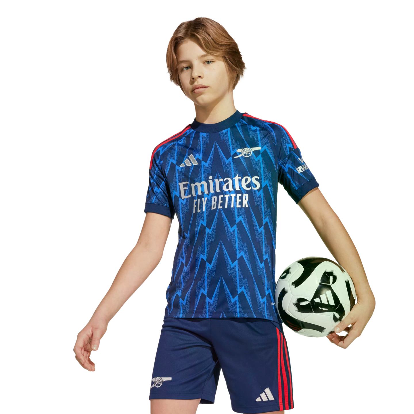 A young person wearing a blue Arsenal soccer kit with a lightning bolt pattern, holding a soccer ball under their arm against a black background.
