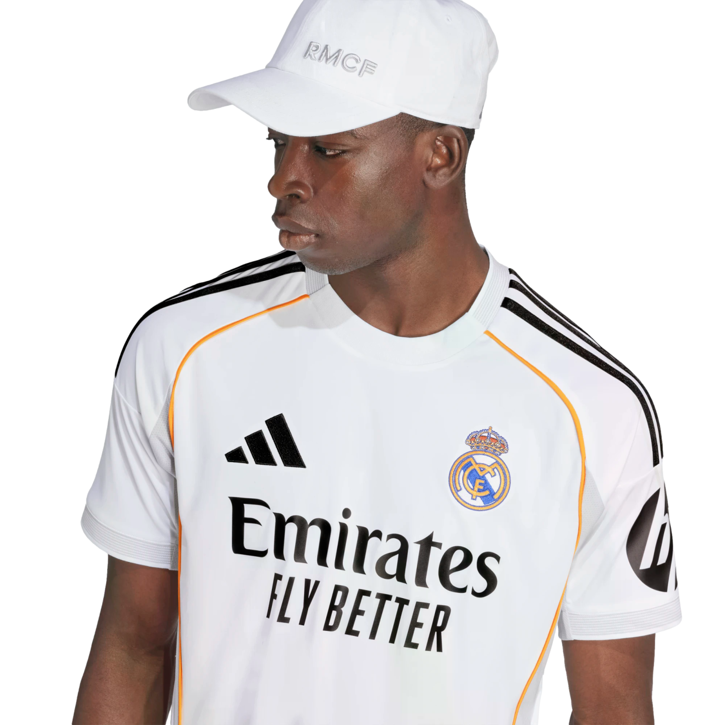 A man wearing a white Real Madrid football jersey and matching white baseball cap against a plain white background.