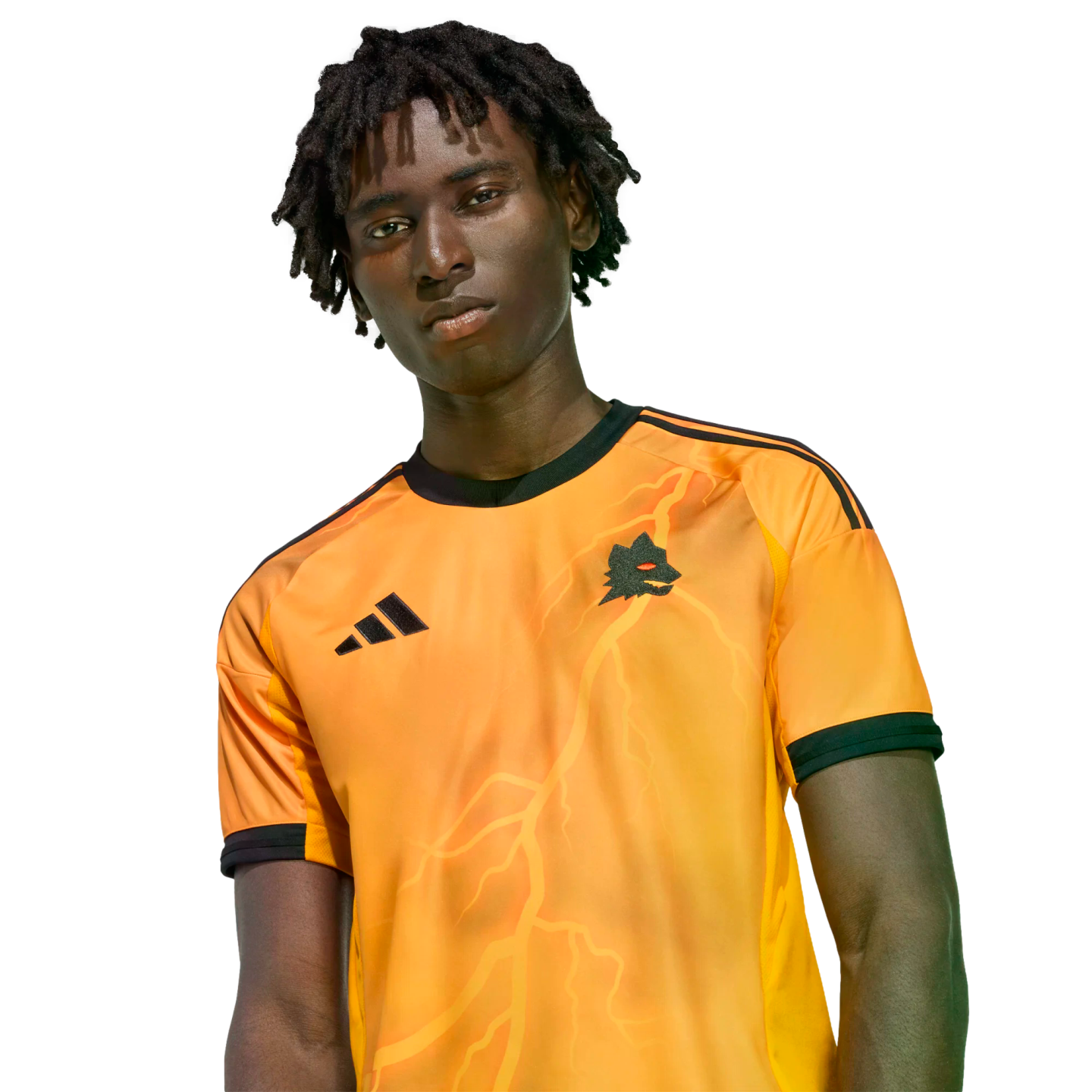 A man with dreadlocks wearing an orange Adidas jersey with a wolf crest and lightning bolt graphics against a black background.