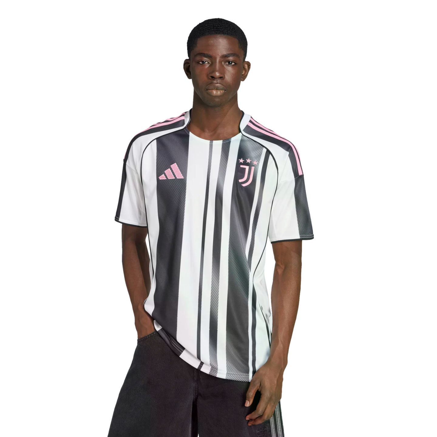 A man wearing a black and white striped Juventus soccer jersey with pink accents, standing against a white background.